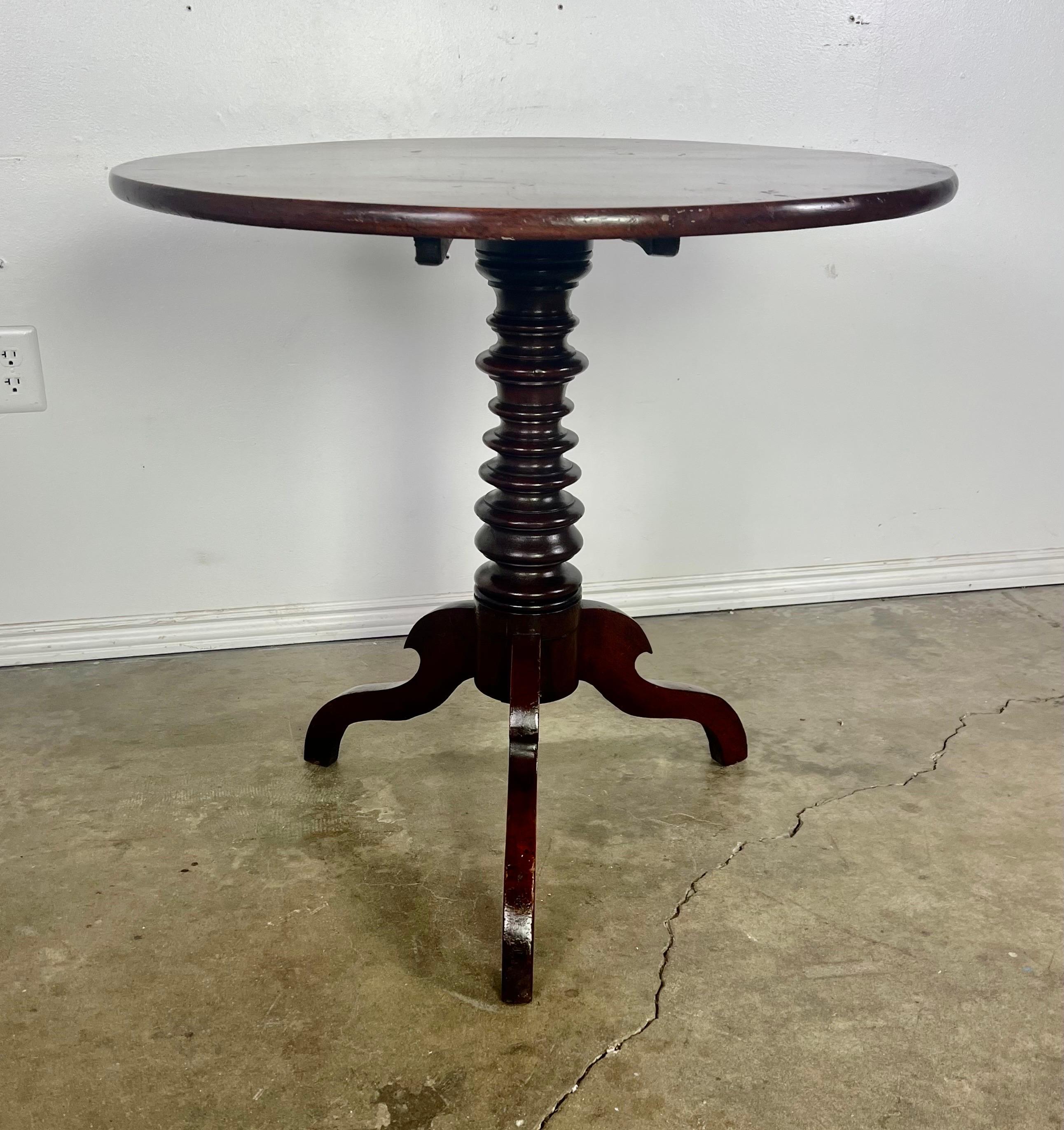 Early 20th century Mahogany tilt top side table.  The beautiful turned column ends in a tripod base.  The top will tilt for easy storage.