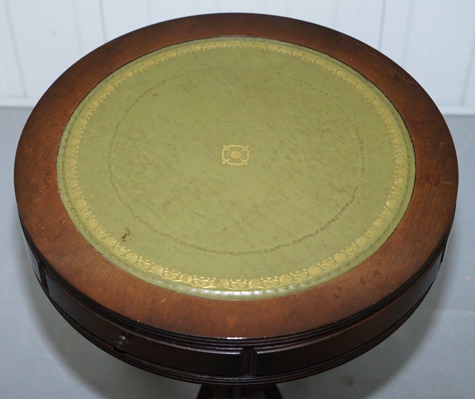 We are delighted to offer for sale lovely side table sized Regency style drum table with twin drawers and green leather top

A very good looking and well made piece in period condition which is to say some patina marks all over, structurally its