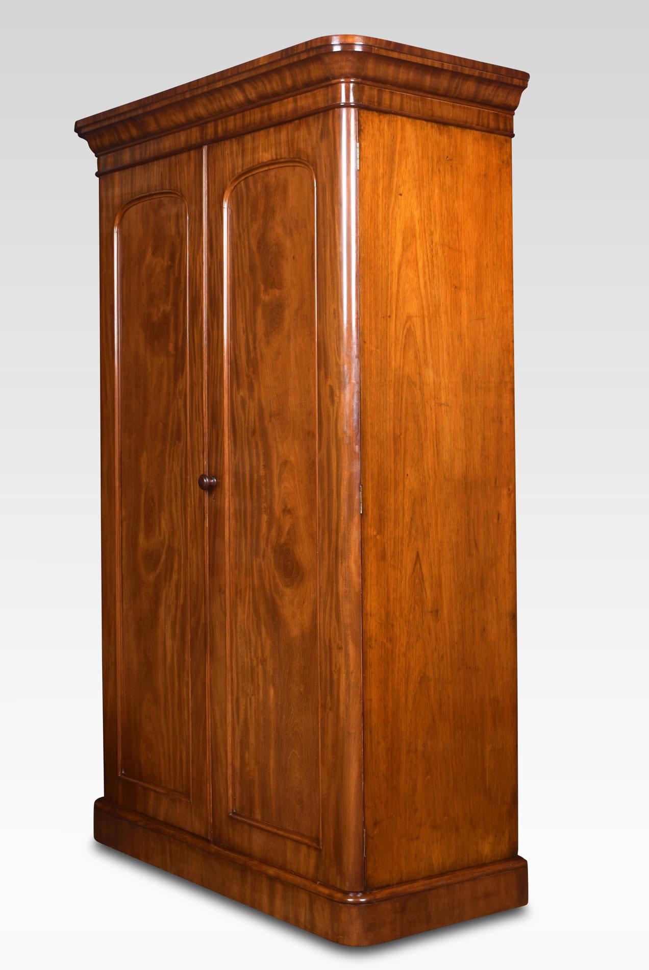 Mahogany two-door wardrobe the projected carved moulded cornice, over two arched doors opening to reveal hanging area, slides and drawers. All raised up on plinth base.
Dimensions:
Height 81.5 inches
Length 51 inches
width 23.5 inches.
