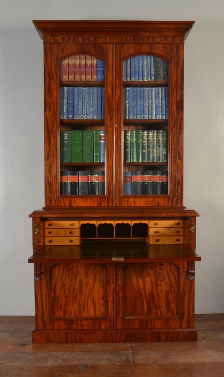 Victorian mahogany secretaire - bookcase, the ogee cornice above a pair of arched glazed doors, enclosing four adjustable shelves, the projecting base with secretaire drawer opening to reveal fitted interior and leather inset above a pair of arched