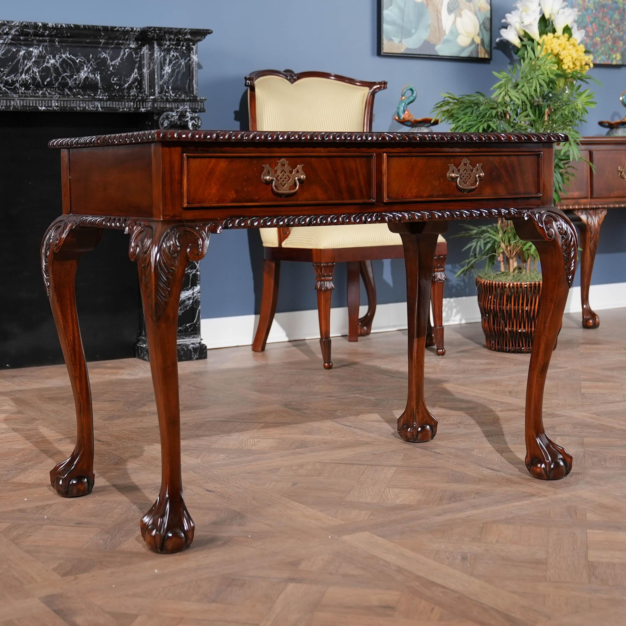 A Chippendale style Mahogany Two Drawer Console with a banded mahogany top, a gadrooned (rope edged)  molding over top a frieze with two dovetailed drawers which feature solid brass pulls. The cabriole legs of our Mahogany Two Drawer Console are