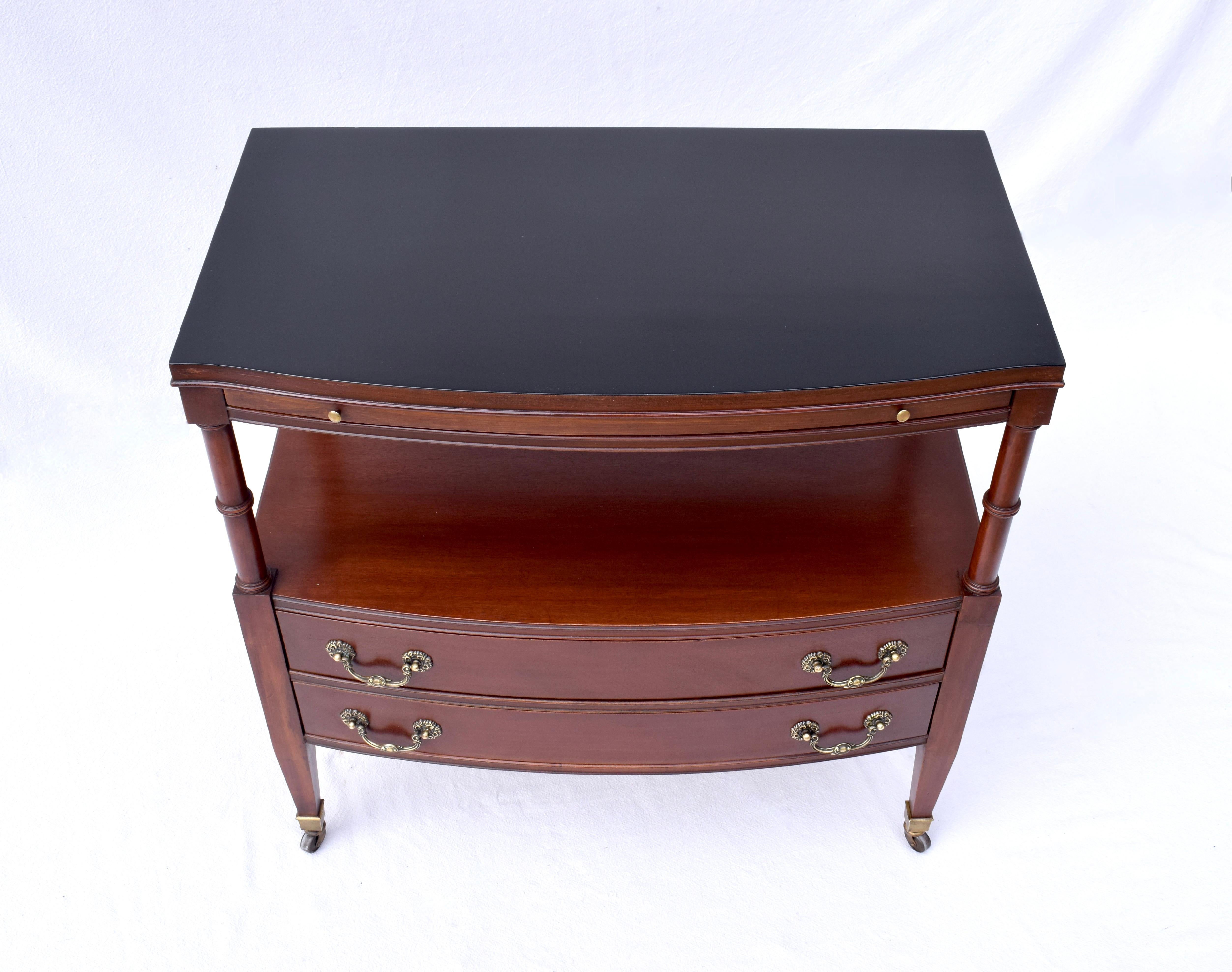 A Versatile Mahogany server in the Regency style featuring two dovetail drawers, a hidden top shelf that pulls out, bottom shelf and overall beautiful Mahogany. Set on brass castors, moveable from room to room, this could be used as a buffet, bar