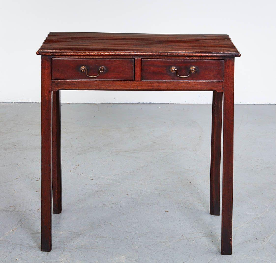 A simple and elegant side table in figured mahogany having a single plank rectangular molded edge overhanging top on straight apron with integral corner brackets on four straight square section legs. Works well in a formal room or as a nightstand
