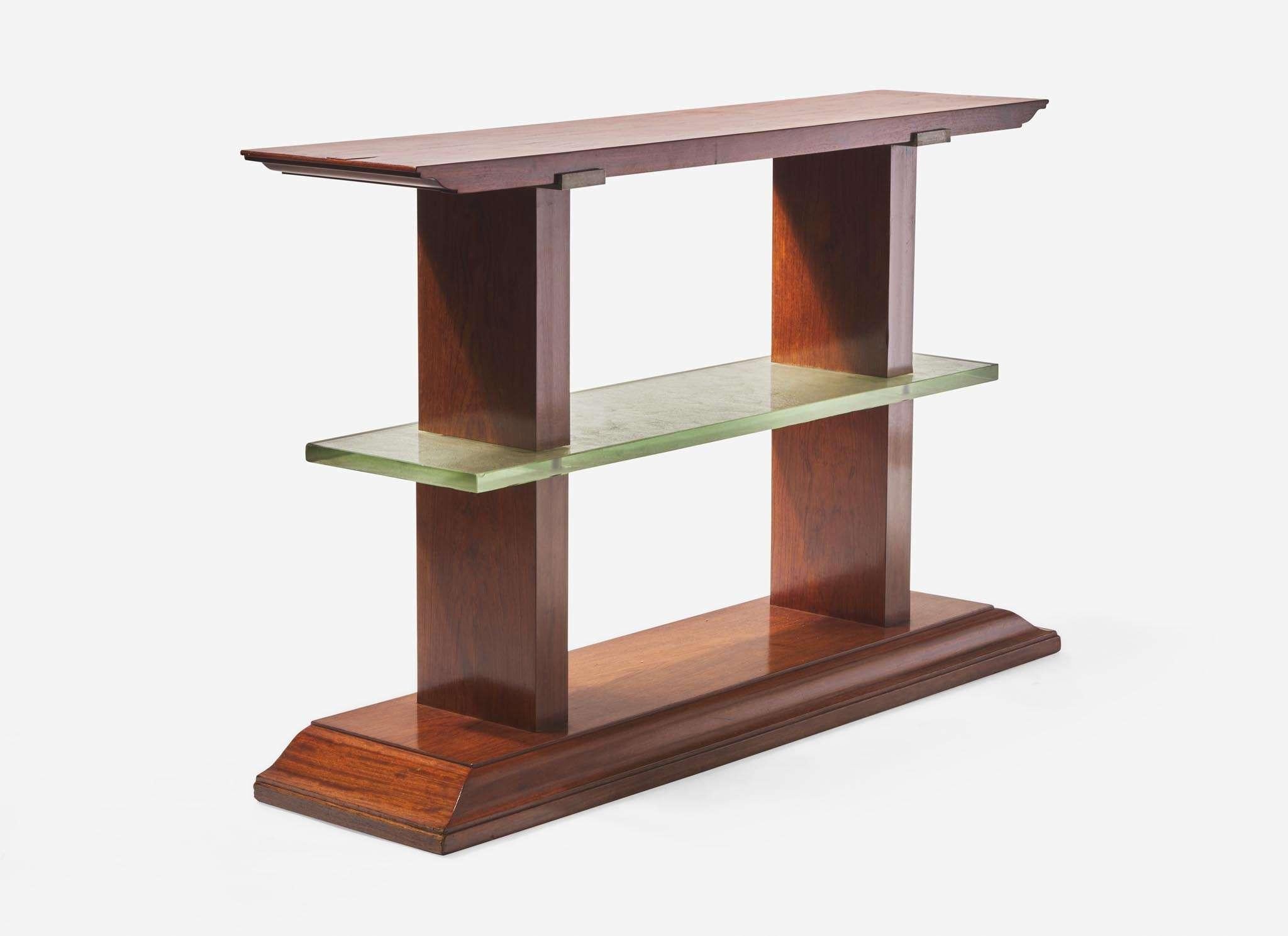 Mahogany Console attributed by Maison Dominique  with upper shelf resting on patinated bronze brackets and the second shelf made of Saint-Gobain glass. Property from a private New York Collection, bought in Paris



 
