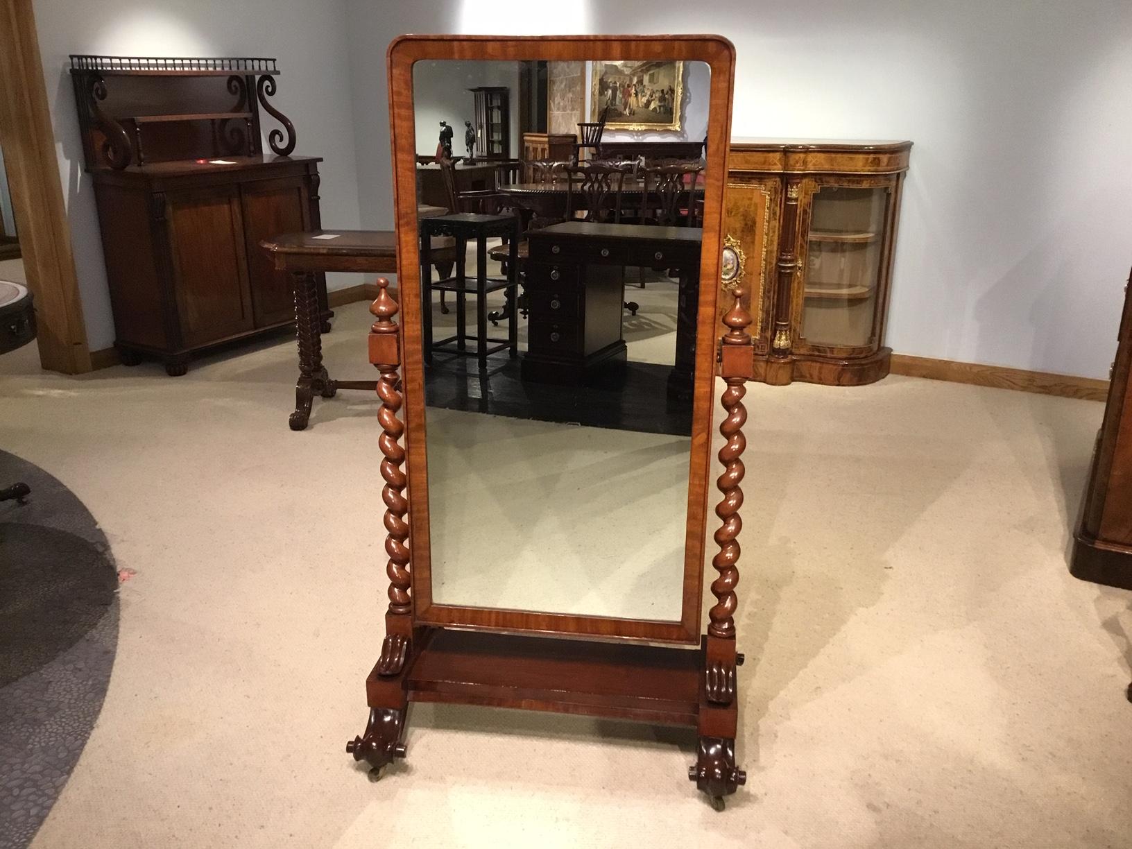 A beautiful mahogany Victorian period cheval dressing mirror. Having a rectangular adjustable mirror in a fine quality mahogany frame, supported by spiral twist mahogany columns with turned finials on a platform base with carved applied corbels. The