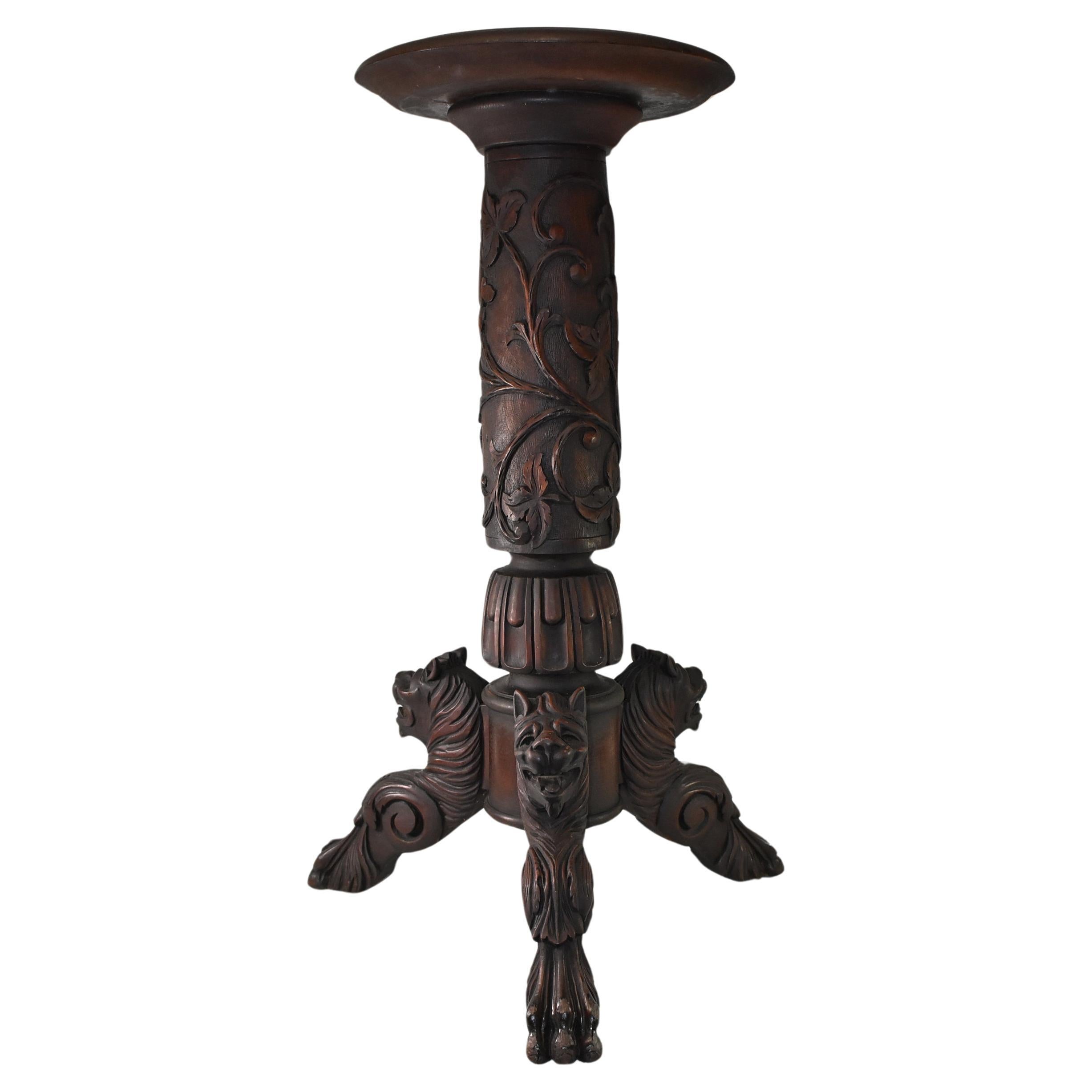 Victorian mahogany plant stand with carved lion heads and claw feet. Three supporting legs center column with carved flowers and vines. Original finish. In the style of R J Horner. 38