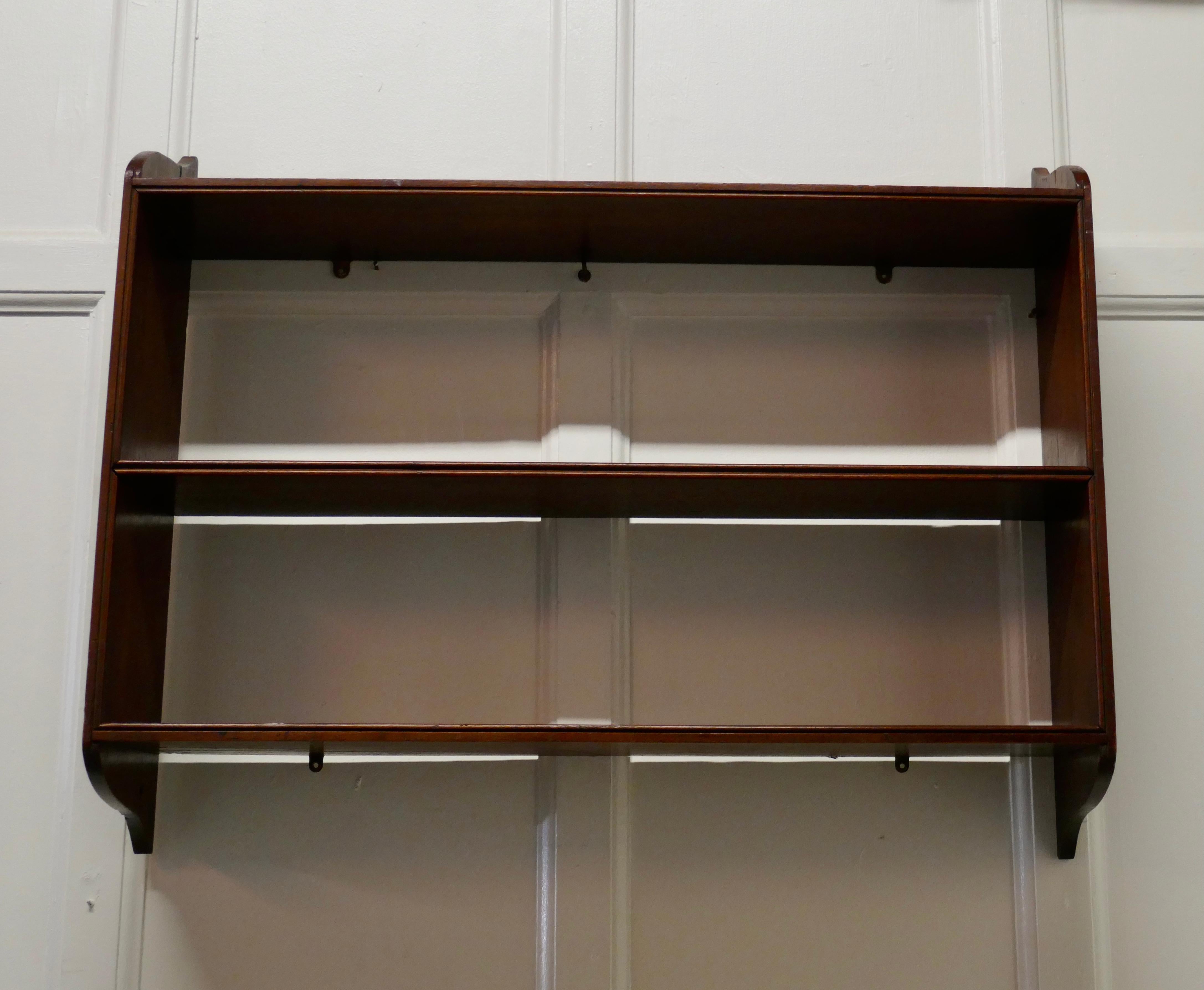 Mahogany wall hanging book shelf.

This charming little shelf unit, has 3 shelves
The shelf is in good condition, with a small piece missing on one side and would work well in the bathroom kitchen or bedroom
The shelf is 7” deep, 33” long and