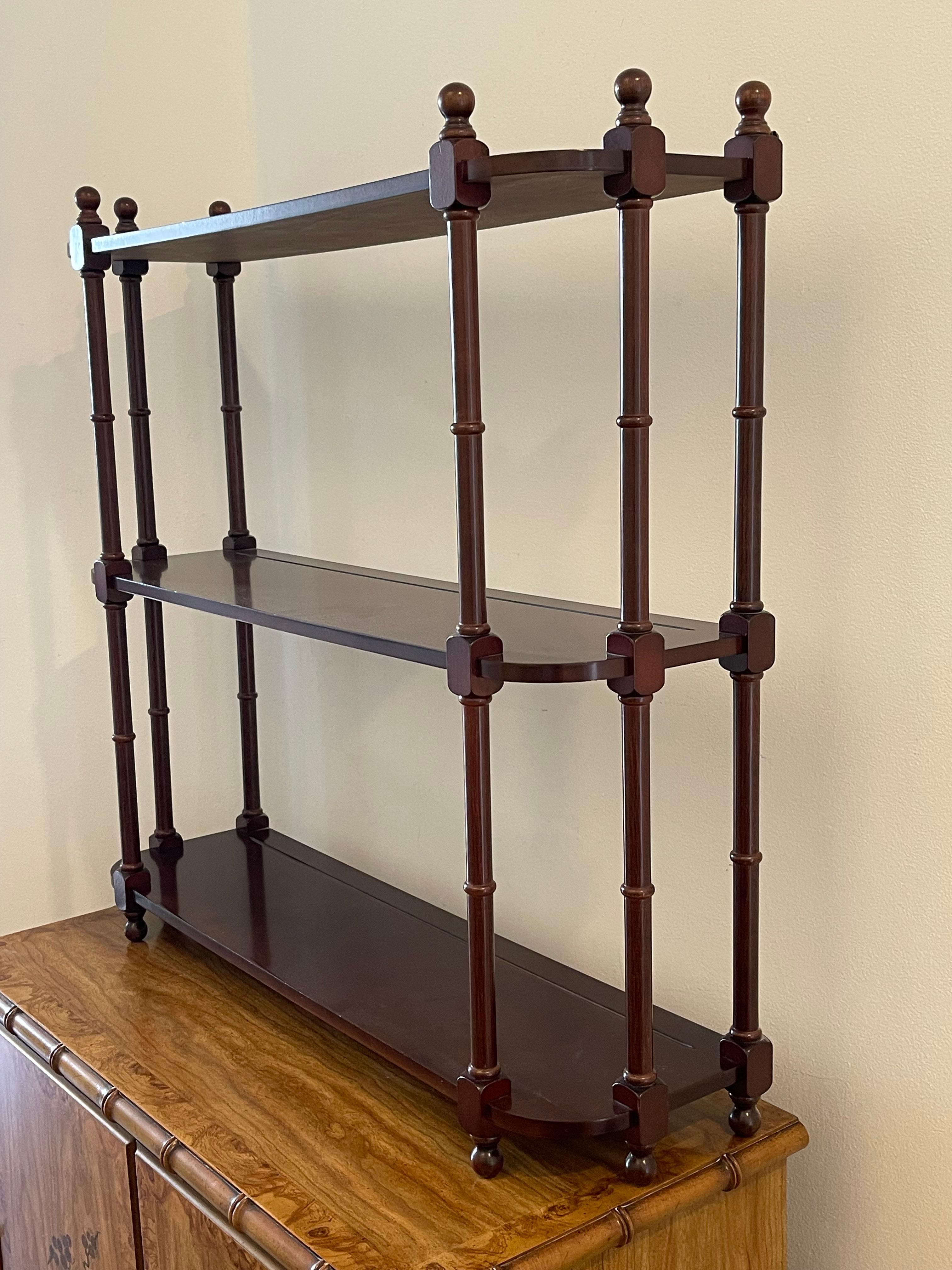 Elegant light British colonial style mahogany wall etagere display.