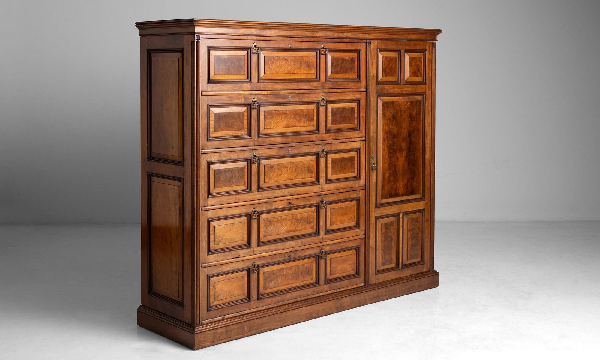 Mahogany wardrobe

England, circa 1890

Finely made cabinet, constructed in solid mahogany with flame mahogany 

panels, reeded moldings and brass handles. The piece also features imported

American locks by Alfred Charles Hobbs.

78”W X
