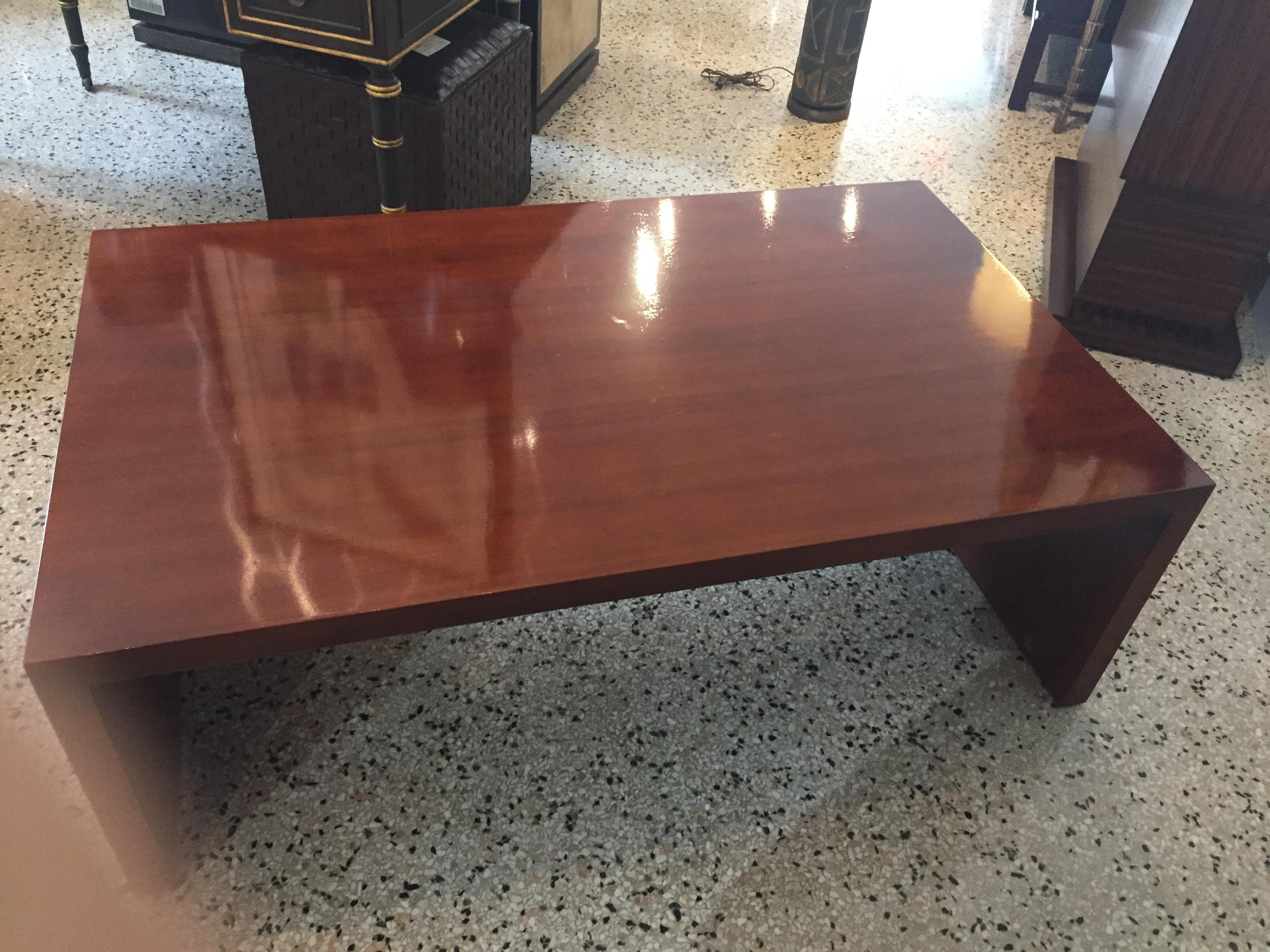 Mahogany waterfall cocktail table in polished wood midcentury minimalism from a Palm Beach estate.

Note, the last picture shows a faint area in the back left corner of sun bleaching -- the section is approximately 4