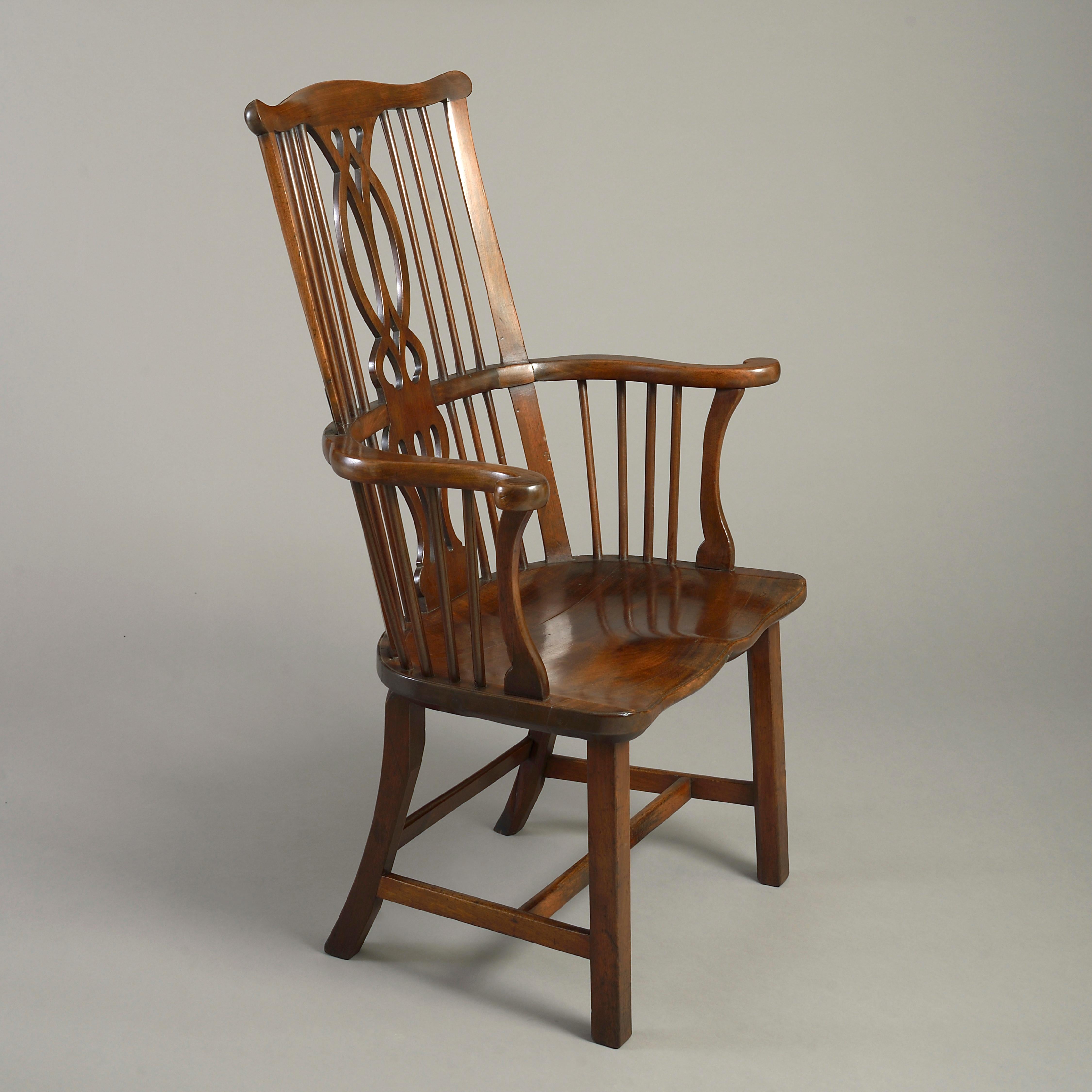 A George III mahogany Windsor armchair with pierced splat and saddle seat, circa 1775.