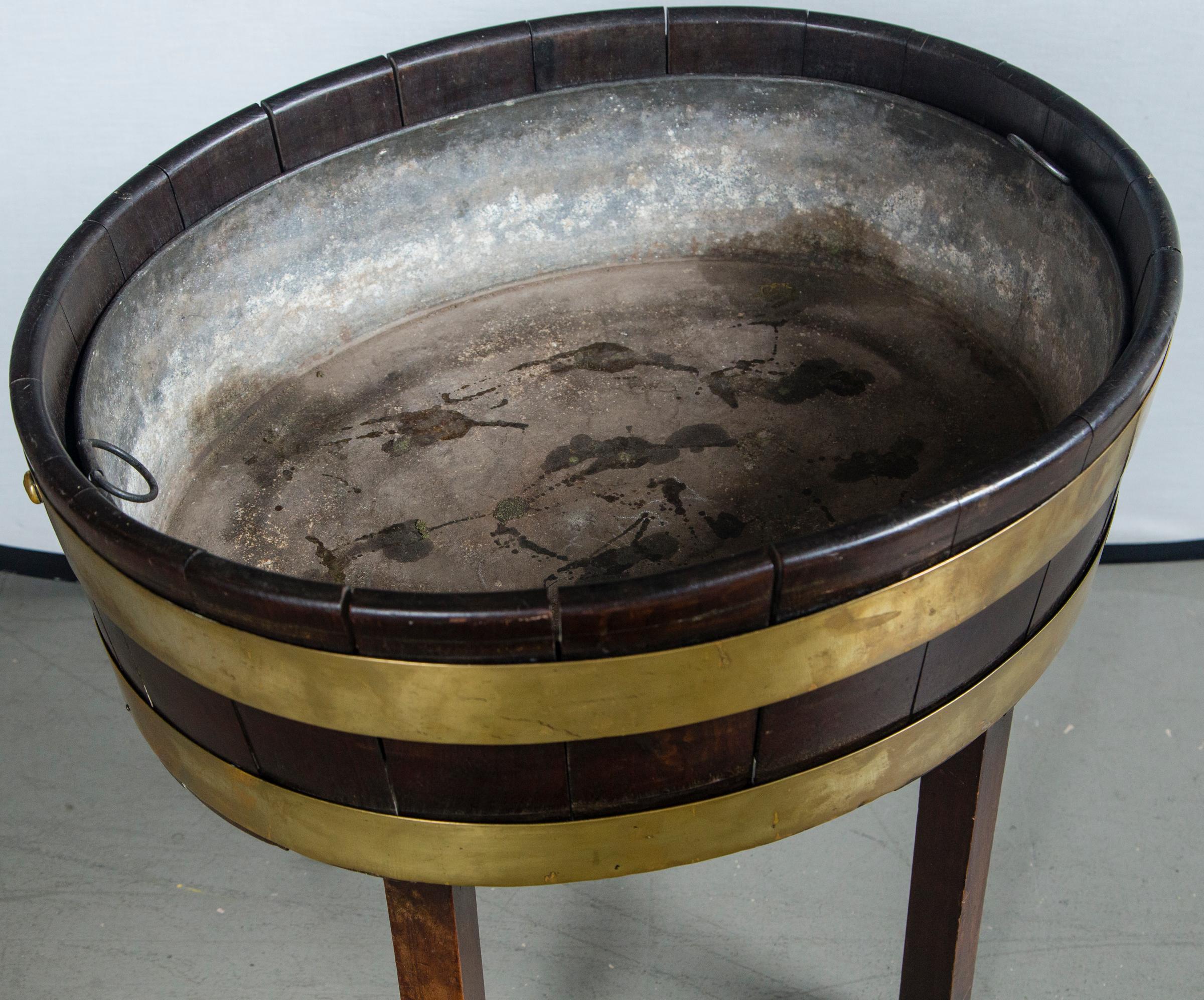 Oval brass banded antique mahogany wine cooler with original tin liner on stand, circa 1880.