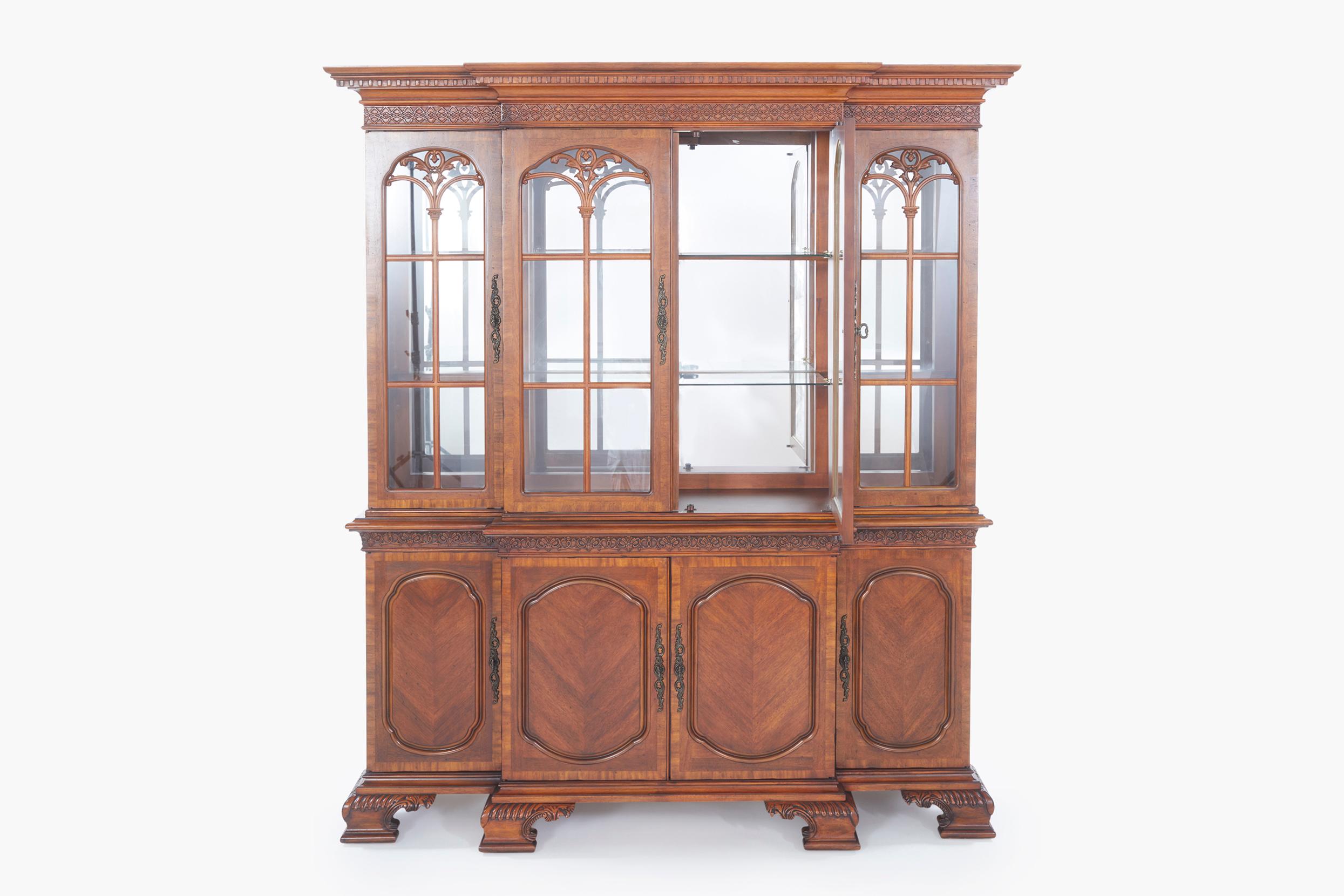 This elegant Italian hand-crafted two-part mahogany china cabinet, also known as a hutch, is a stunning addition to any dining or living room. The cabinet features interior glass shelves and a mirror backsplash that enhances the display of your fine