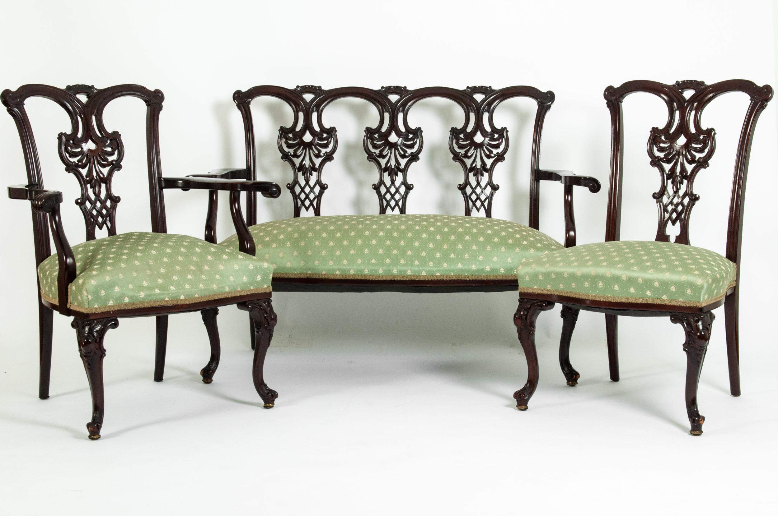 Early 19th century mahogany wood frame Chippendale style three-piece salon suite. The set include one settee, one armchair, one side chair. Each piece is very sturdy and in excellent antique condition with appropriate wear consistent with age.