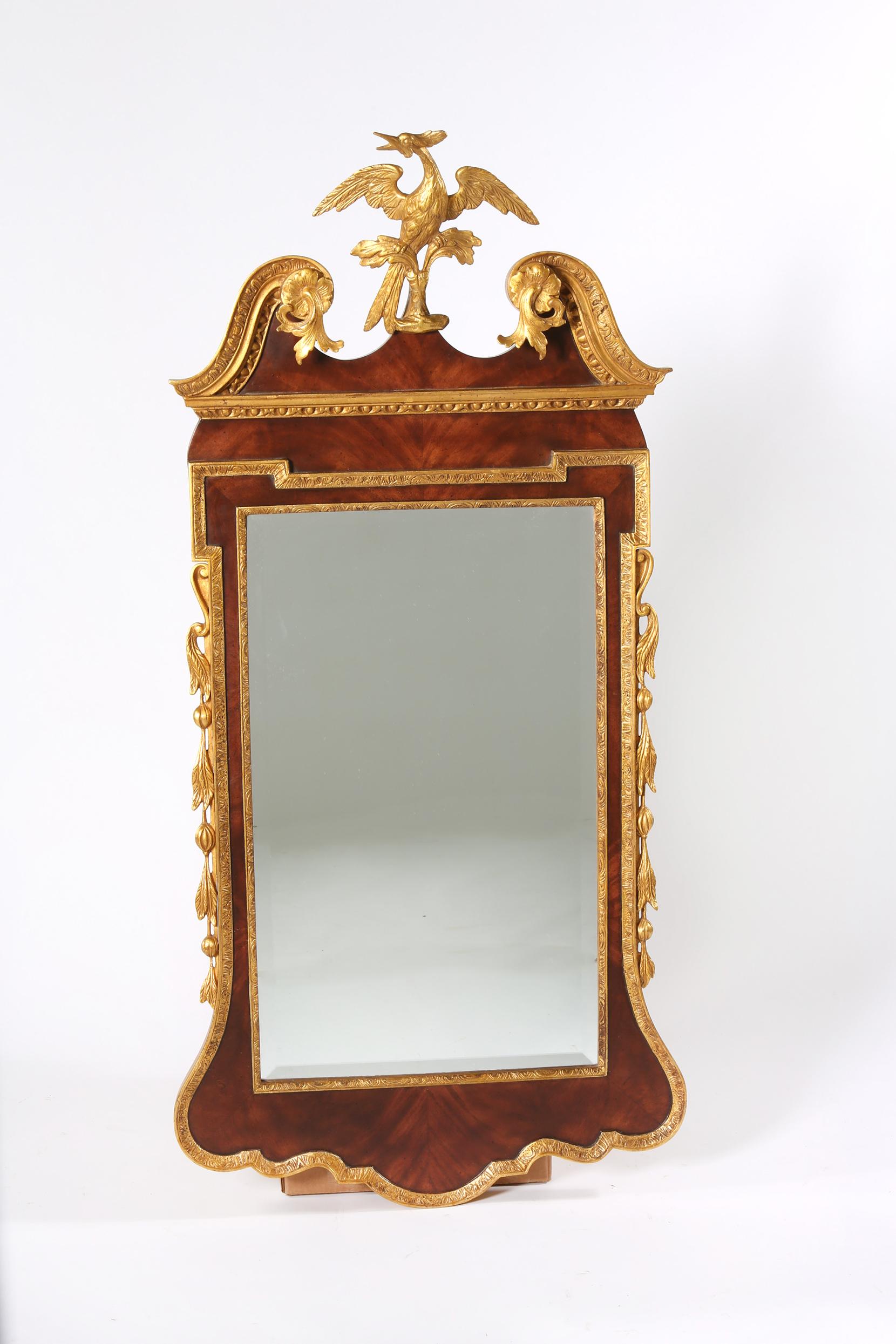 Mahogany wood hand carved framed with gilt bird crown top hanging wall mirror. The mirror is in good condition with minor wear consistent with age / use. Repaired made to the bird crown top / restored and refinished. The mirror measure about: 53