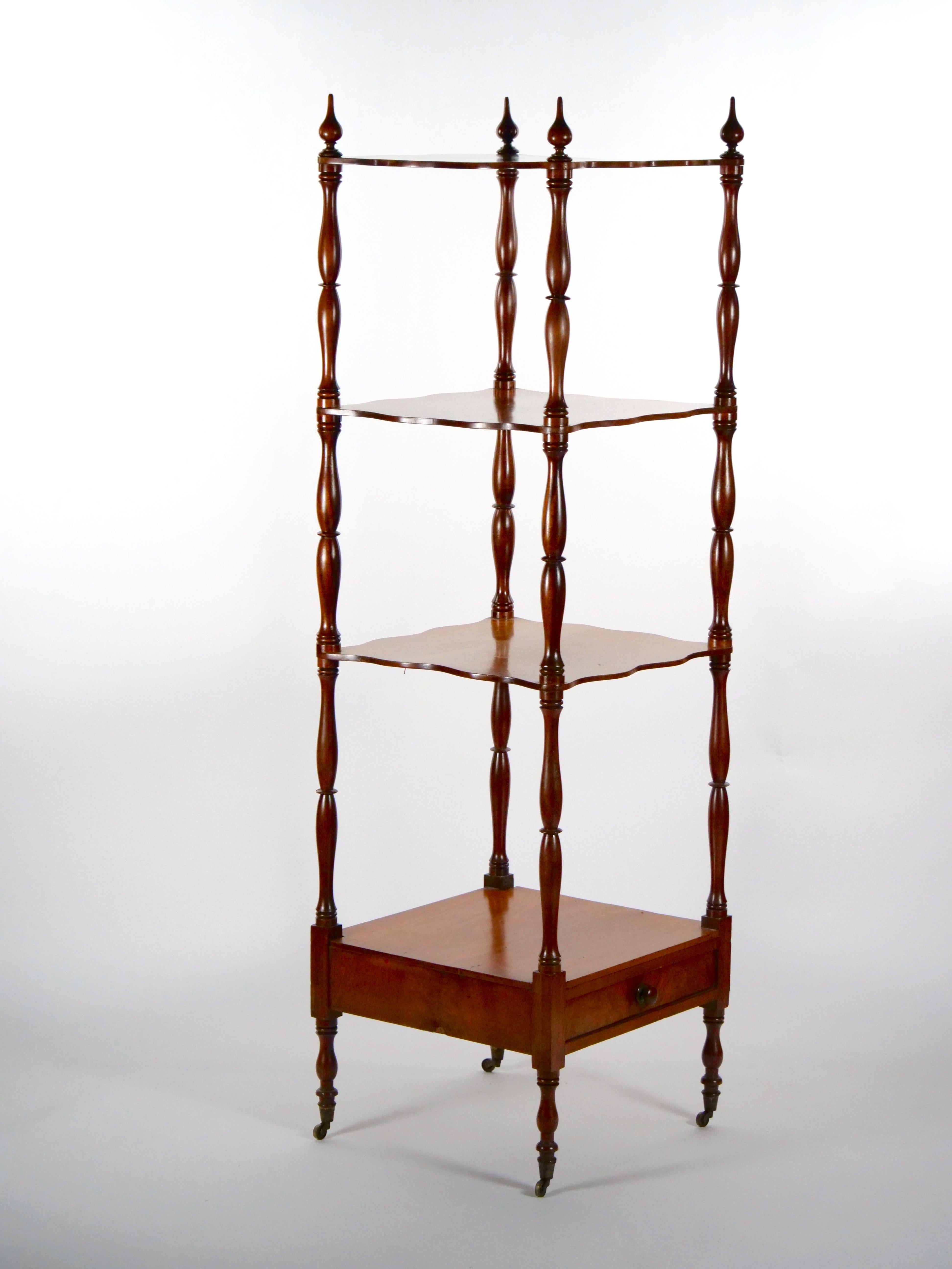 English Regency style mahogany wood four tiered display etagere with single drawer below lowest shelf. The display etagere features four turned ball finials at each corner of upper gallery resting on four feet. It is in great condition with minor