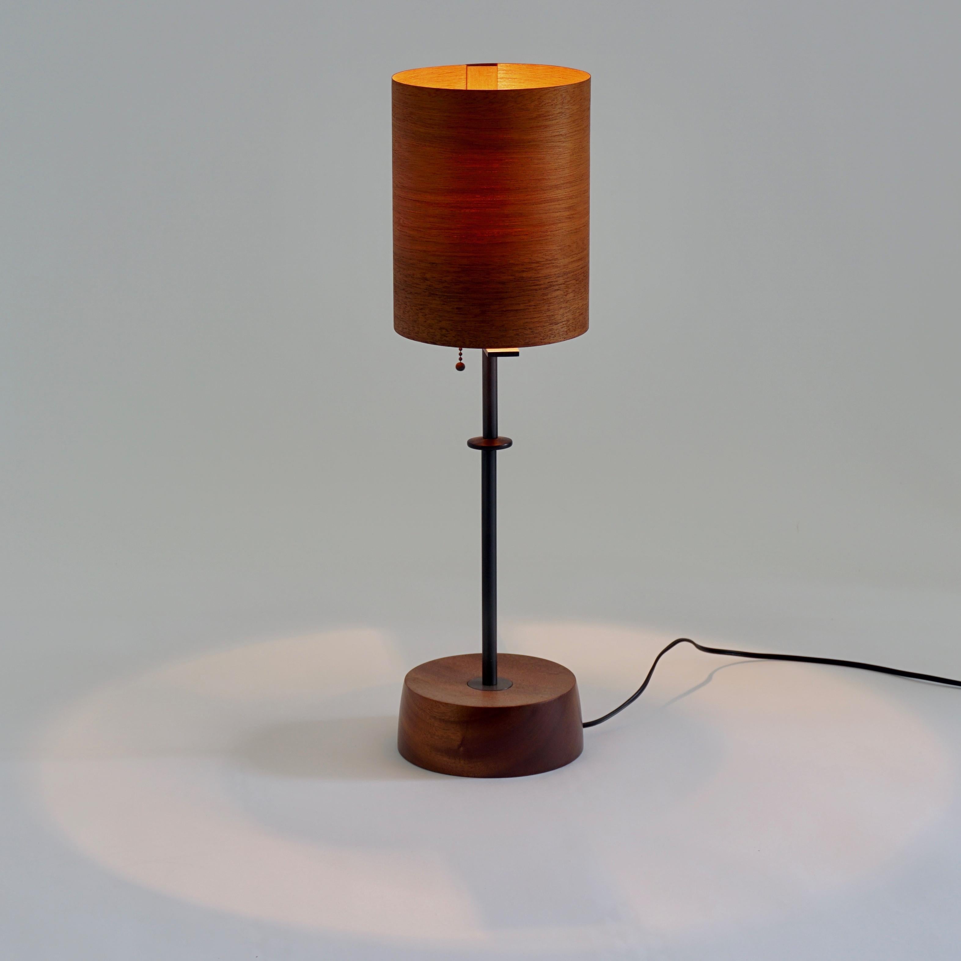 The mahogany veneer lamp #2 is part of the original Lehrecke Veneer Lighting Collection from 1998. The idea began with the beautiful way light passed through thin wood veneers. The mahogany has a lovely reddish-orange color when off and a