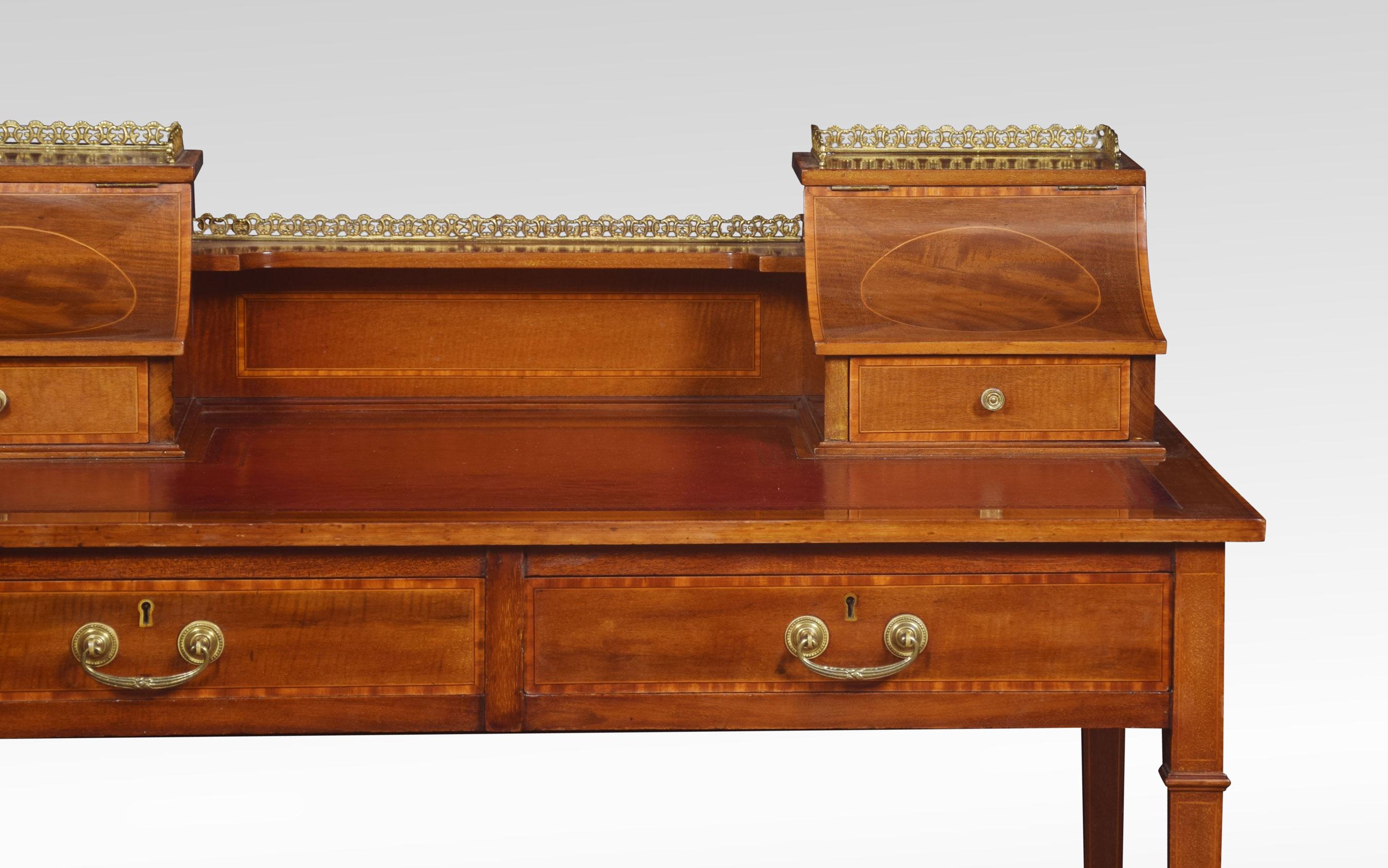 Mahogany and fruitwood inlaid ladies writing desk. The superstructure with central shelf flanked by sloped lidded piers, each with a single drawer. The shaped molded edge top with inset Burgundy leather writing surface, above a two short frieze