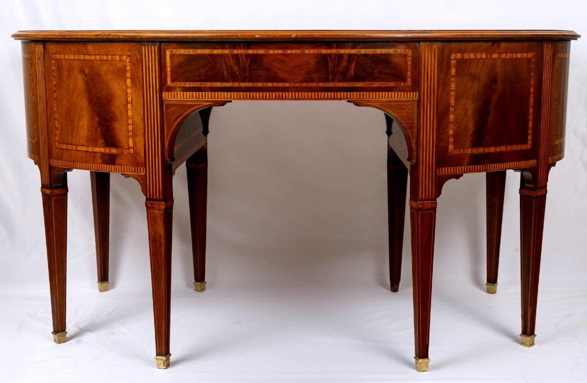 A delightful antique writing table in mahogany, in the form of a 