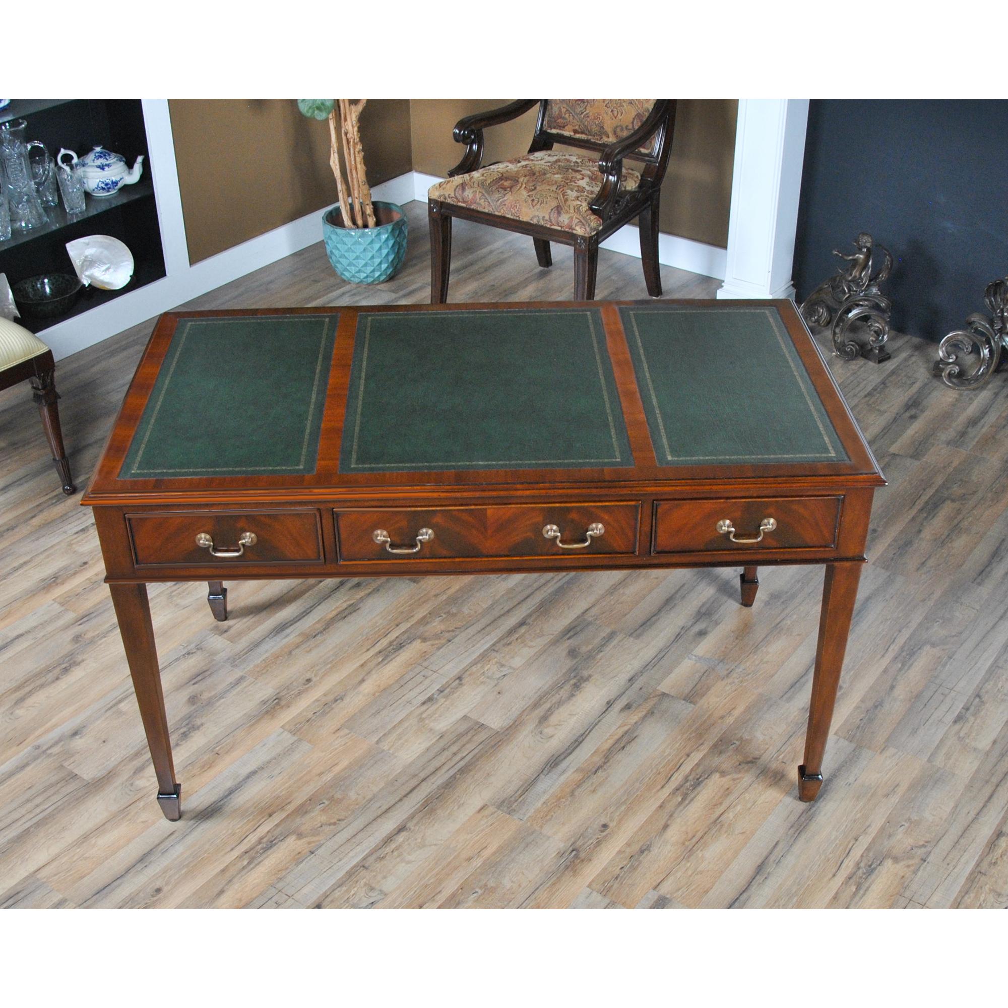 An elegant Mahogany Writing Table Green Leather by Niagara Furniture which is a perfect fit for use either at home or in the office. Features include a three panel green genuine full grained leather tooled top, solid mahogany molded edge profile,