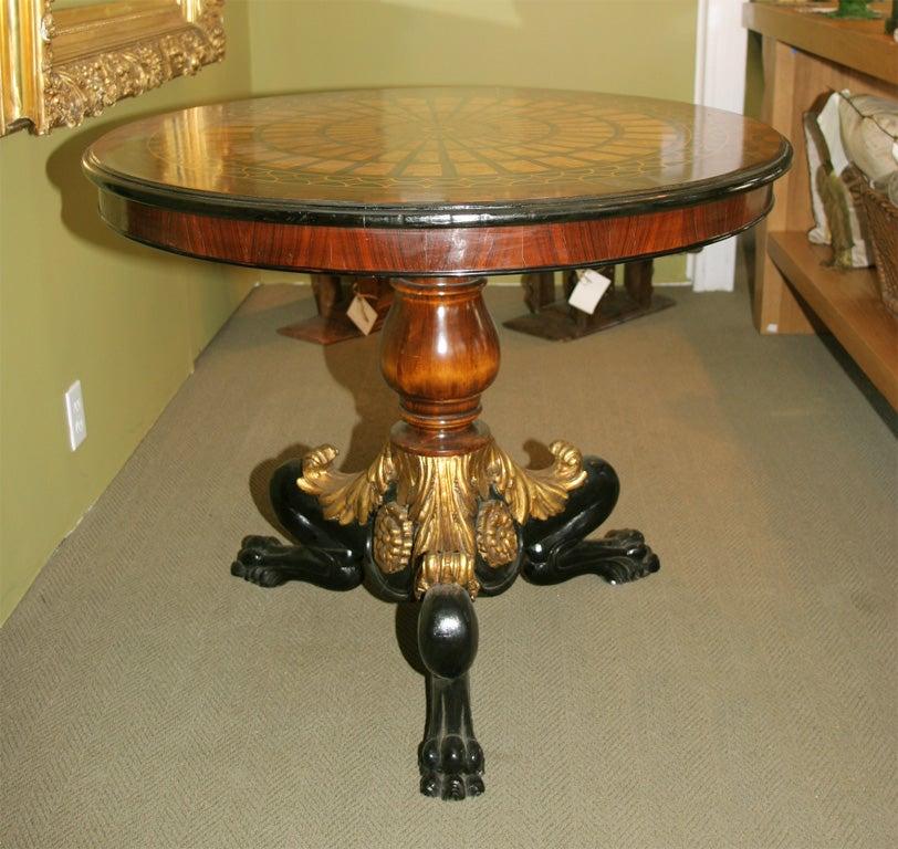 Inlaid wood parquetry design top with gilt and ebonized wood base.
   