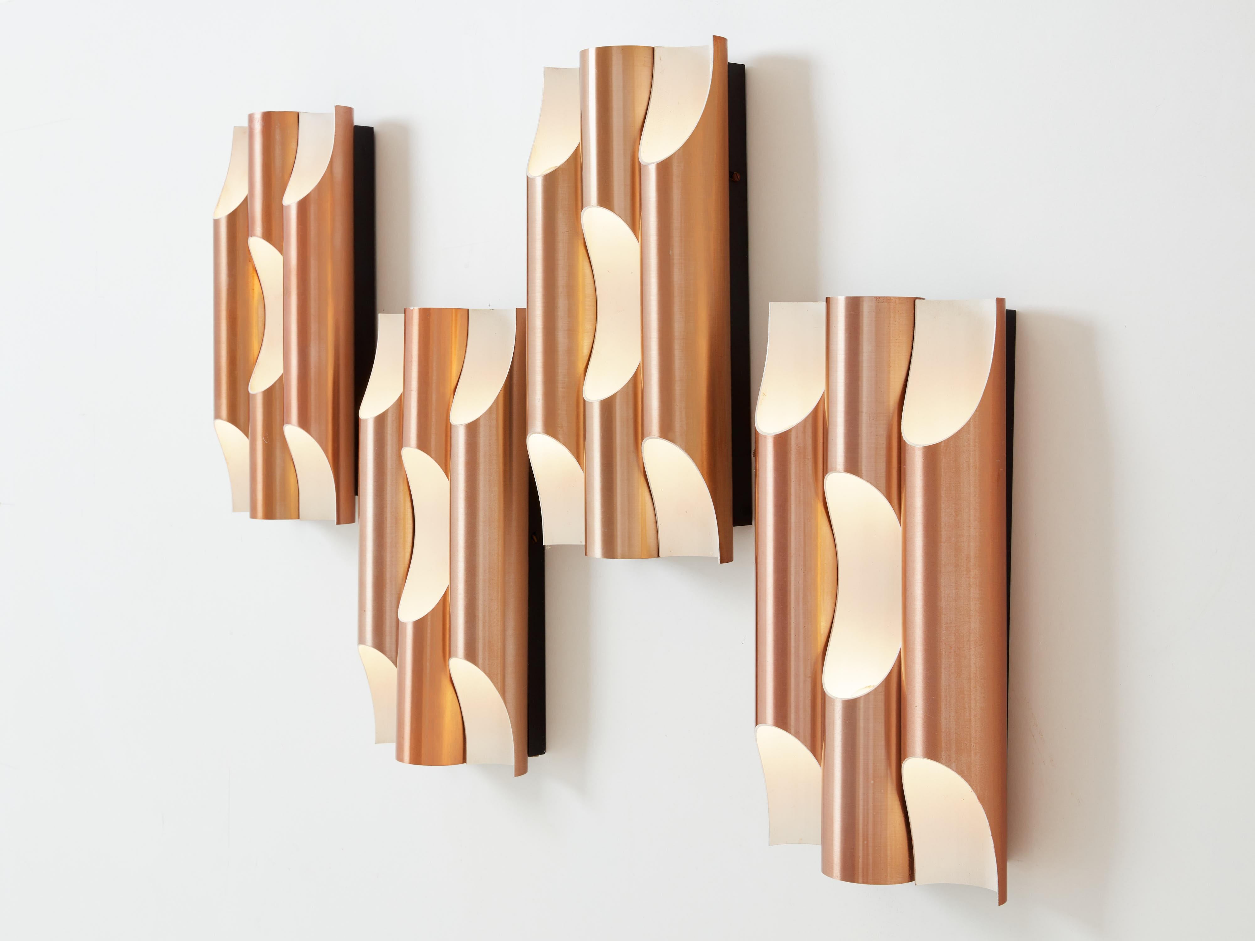 These beautiful Fuga wall lamps were designed at the end of the 1950s by the Finnish architect Maija Liisa Komulainen for RAAK Amsterdam. Each wall light is made of three tubes, designed as organ pipes, made out of aluminium, copper plated on the