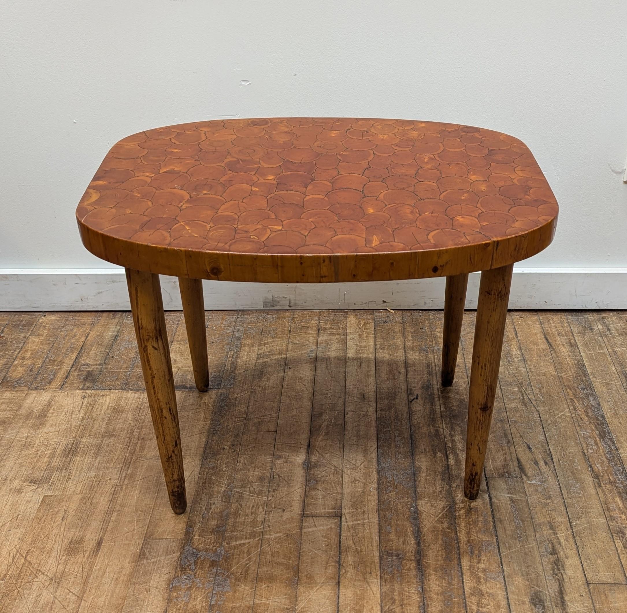A rare early Scandinavian Modern Side Table by Maija Taimi for Kalevala Koru, Finland.  Simple organic style showcasing a modern aesthetic composed of Pine wood with a table top decorated with Juniper wood pieced mosaic.  Signature of KK (Kalevala