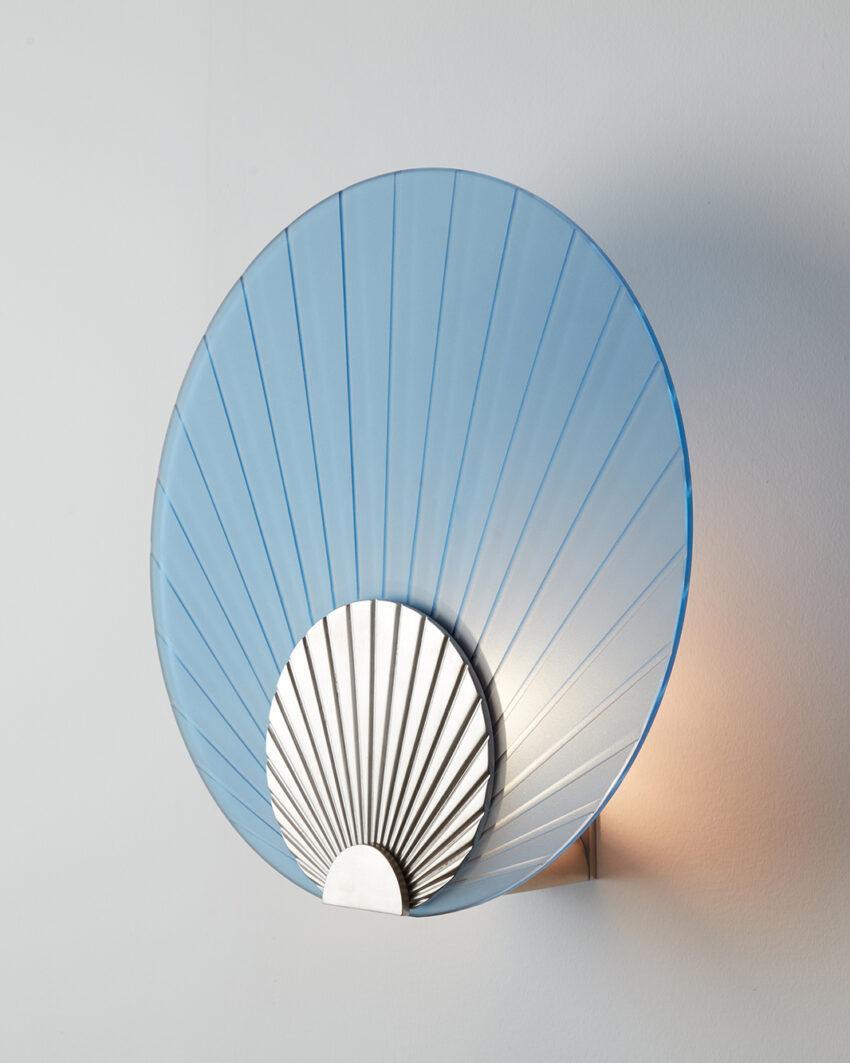 Maiko Indigo Glass And Brushed Stainless Steel Wall Mounted Lamp by Carla Baz
Dimensions: Ø 35 x D 14 cm.
Materials: Brushed stainless steel and indigo glass.
Weight: 3,5 kg.

Available in different finishes: verdigris metal, brushed brass, brushed
