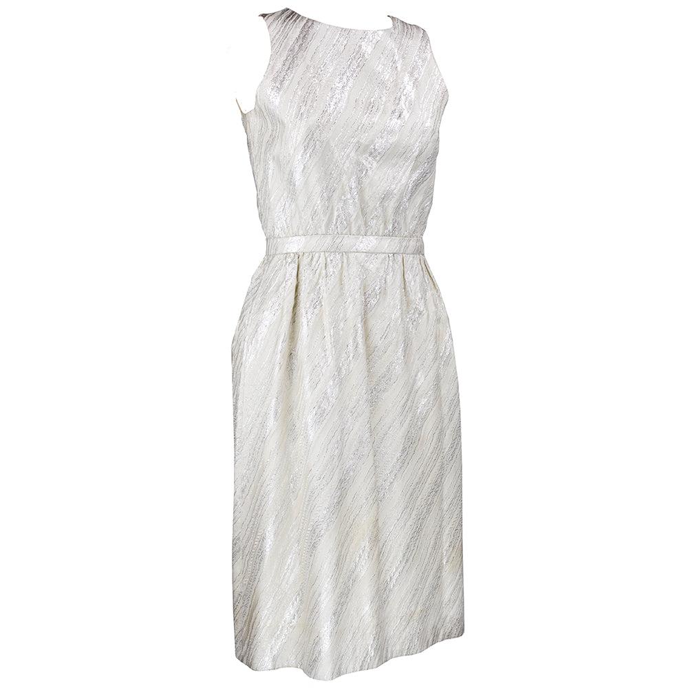 Gorgeous 1960s ensemble from American couturier, Mainbocher, includes a sleek dress and jacket done in the most beautiful silver lamé brocade. Brocade is woven into patterns of organic striations in shades of creamy white, subtle metallic gray and
