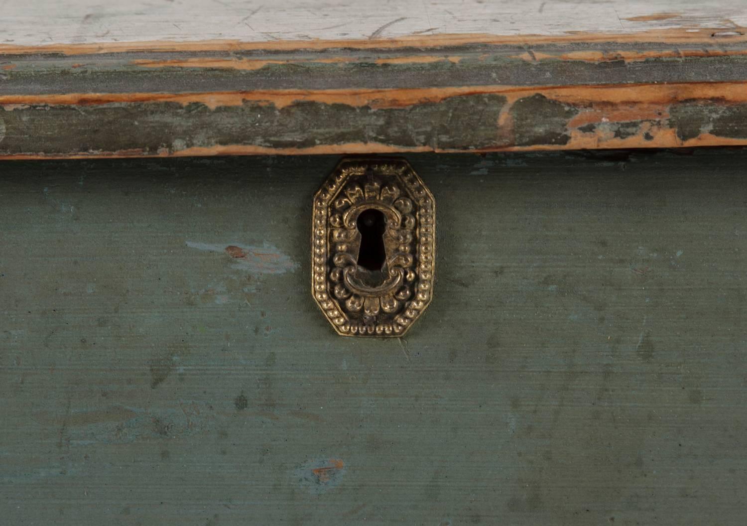 Six-board Maine blanket chest, found at an estate in Gardiner, Maine, with reverse sweetheart, bootjack ends and with a sweeping scallop extending from tall, applied feet. The top has an ogee-molded edge. The brass escutcheon was perhaps added later