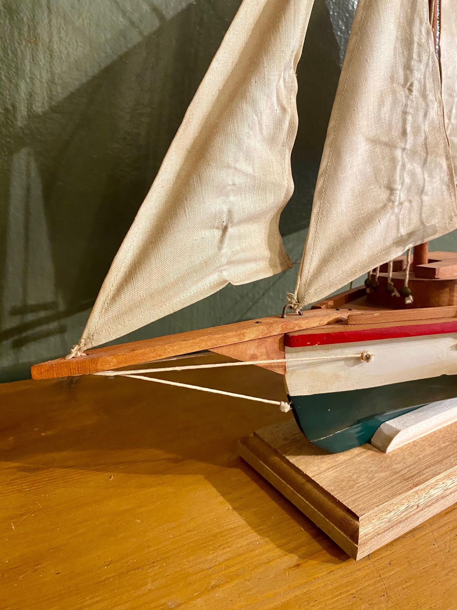 Early vintage Maine Folk Art Model of a Friendship Sloop, circa 1940s, a handmade scratch-built plank on frame model of the iconic cutter rigged sloop hailing from Friendship, Maine. Model is an accurate scale replica of the famous small craft, in