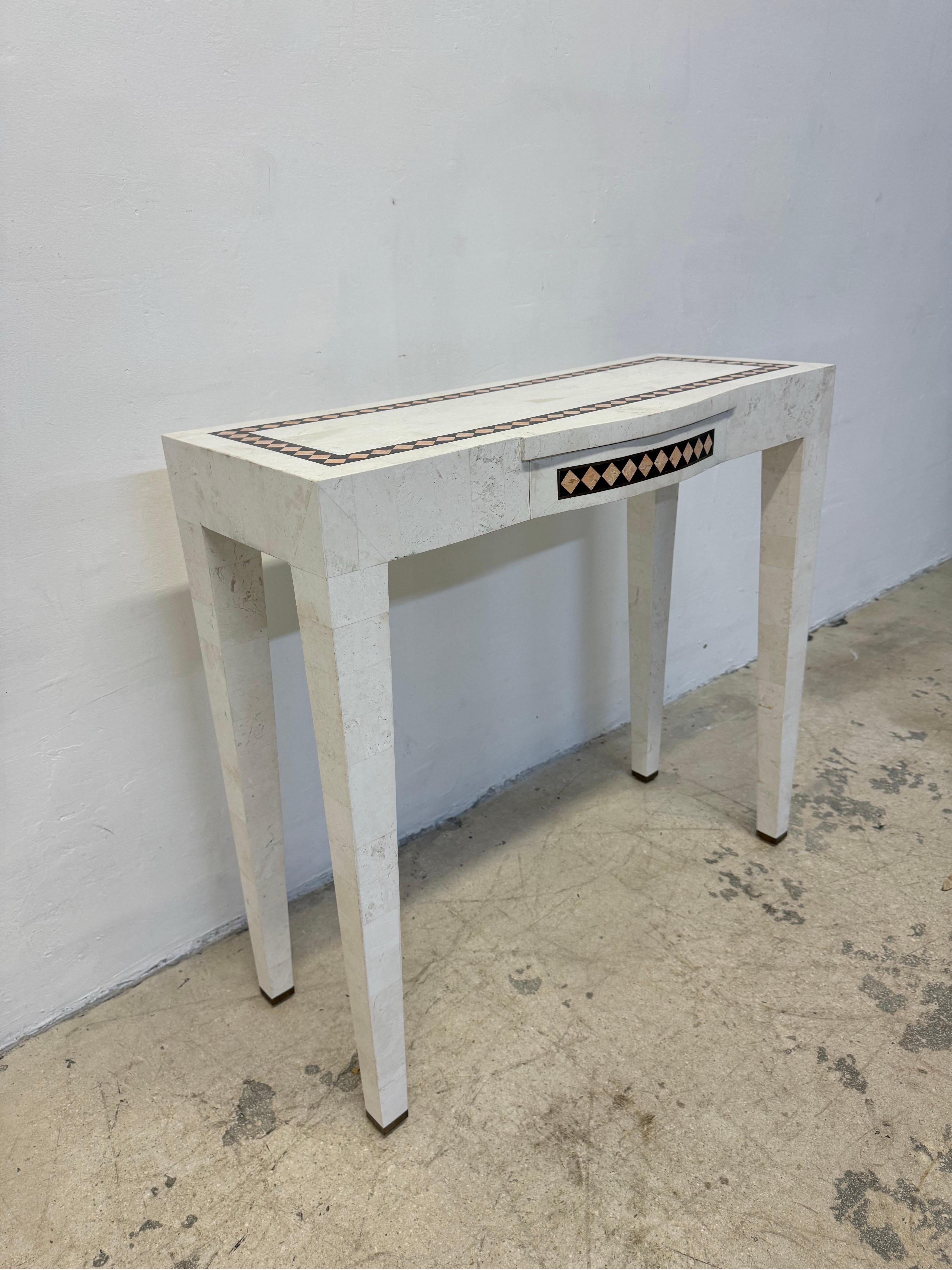 Mid-Century Maitland Smith vanity, small writing desk or console table made with tessellated stone and brass inlay circa 1970s.  There is a small drawer and the legs have brass caps.