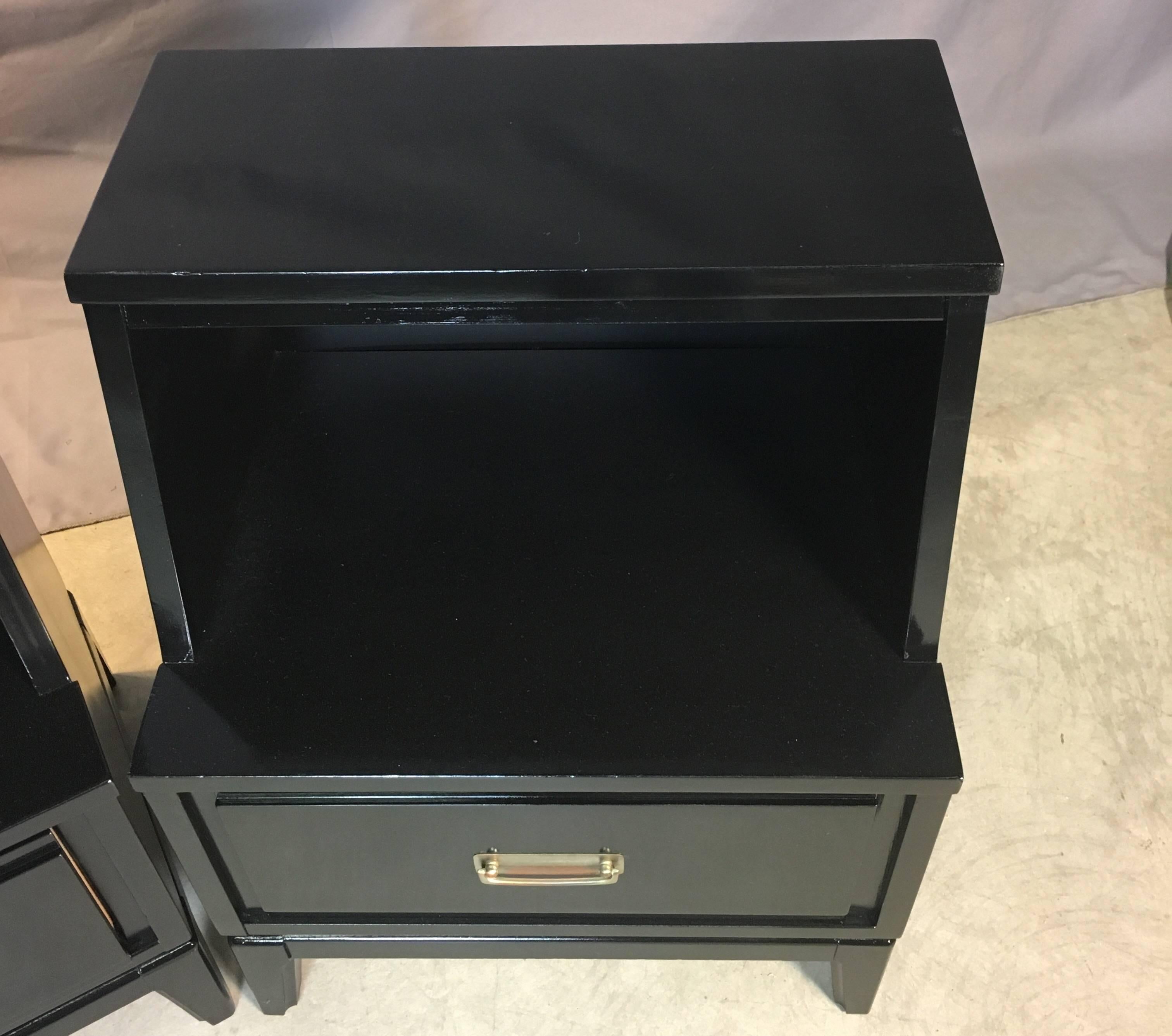 Mid-Century Modern pair of nightstands for Mainline by Hooker in black lacquer. Newly refinished and painted. Marked. Measures: Shelf height is 15.5in.H.