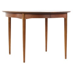 Mainline by Hooker Mid-Century Round Walnut Expanding Dining Table with 2 Leaves