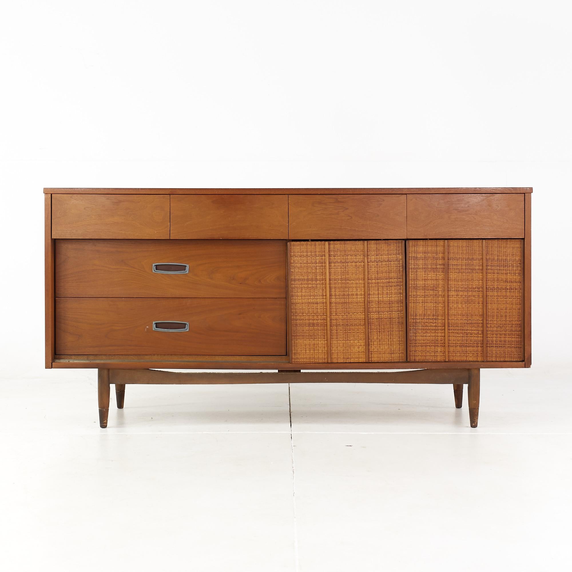 Mainline by Hooker mid century walnut and cane reversible door lowboy dresser

This dresser measures: 64 wide x 20 deep x 31.75 inches high

All pieces of furniture can be had in what we call restored vintage condition. That means the piece is