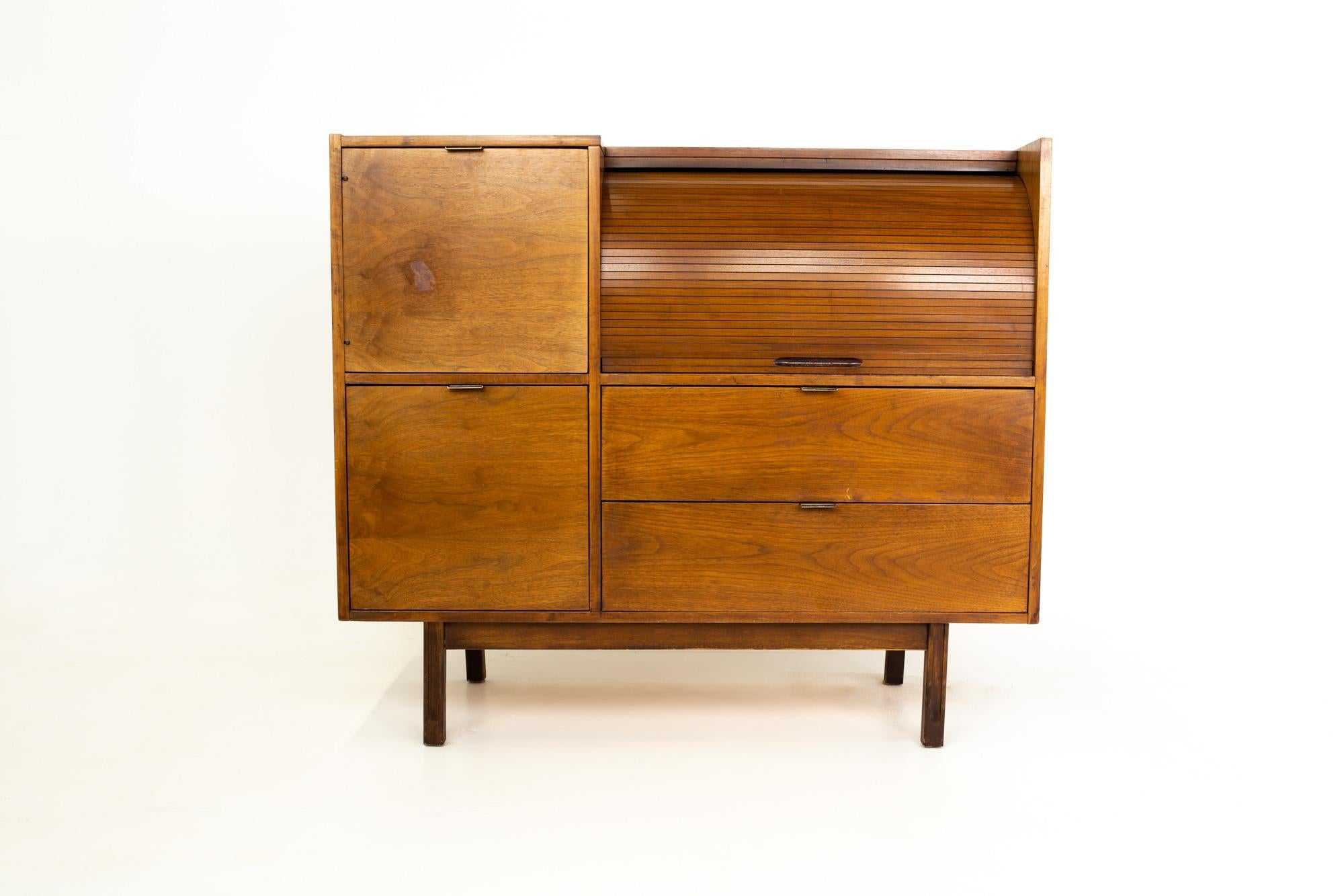Mainline by Hooker Mid Century walnut roll top secretary desk.
Desk measures: 49.75 wide x 20 deep x 43.5.

Each piece is available in what we call restored vintage condition. That means the piece is permanently fixed upon purchase so it’s free of
