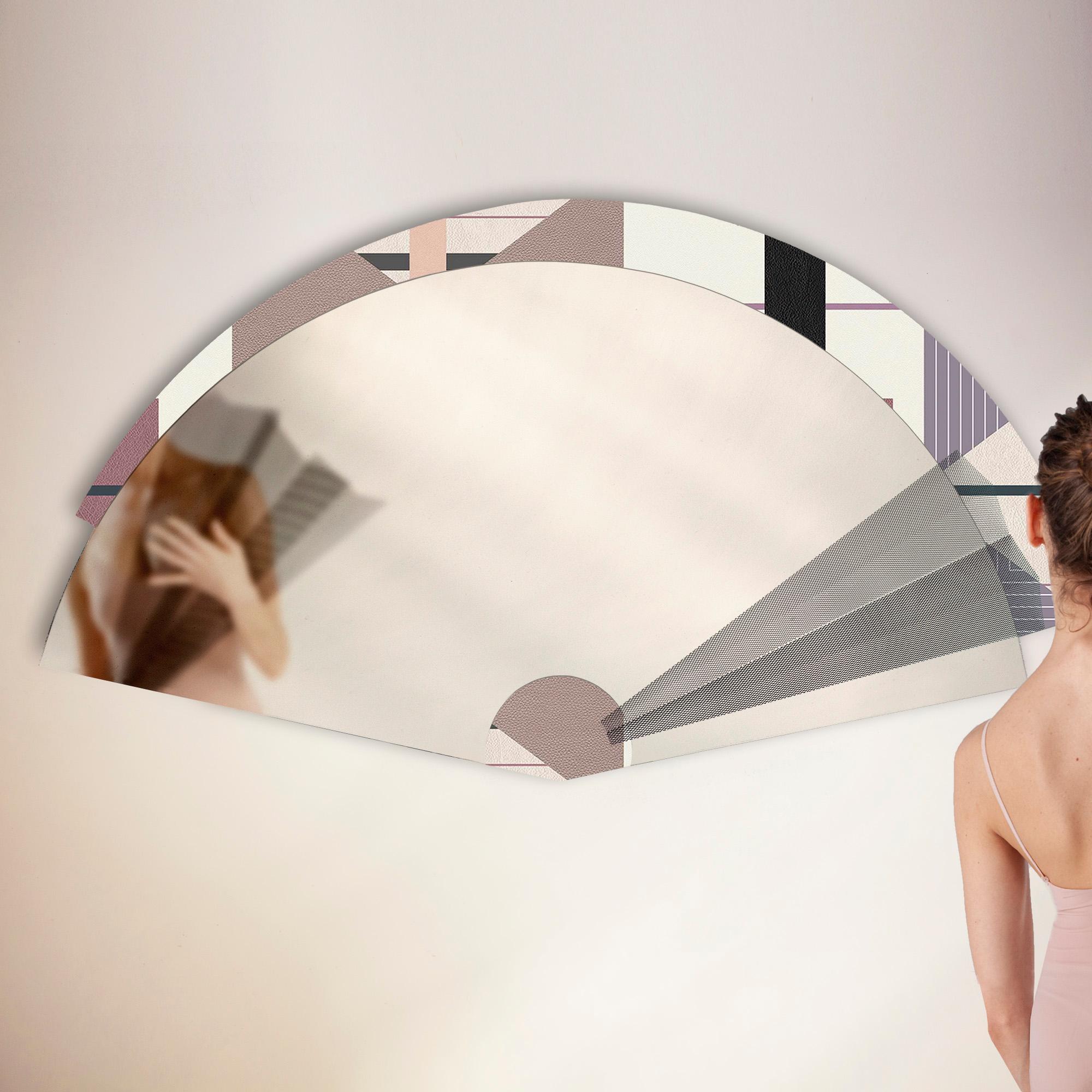 Maiohgi is a fan-shaped contemporary wall mirror, whose surface rests on a colorful graphic border with Bauhaus references. Created by Jacobsroom Studio in Rome, the accessory is completed by six magnetic segments in very light metal mesh that can