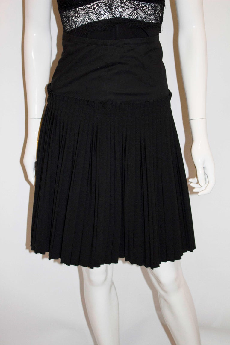 A chic , and easy to wear skirt by Maiscon Martin Margella. In  a black wool mix, the skirt is unworn ( has tags) and has pleats starting at hip leval.
Size 36 Waist 24'', length 24''