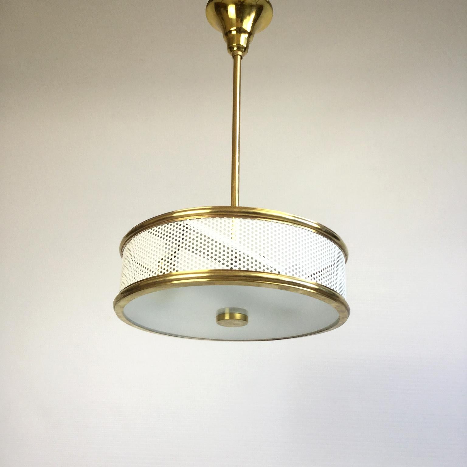 Hanging lamp from the 1950s with a white perforated metal lampshade and a frosted glass
Completely rewired with 2 lamp sockets.