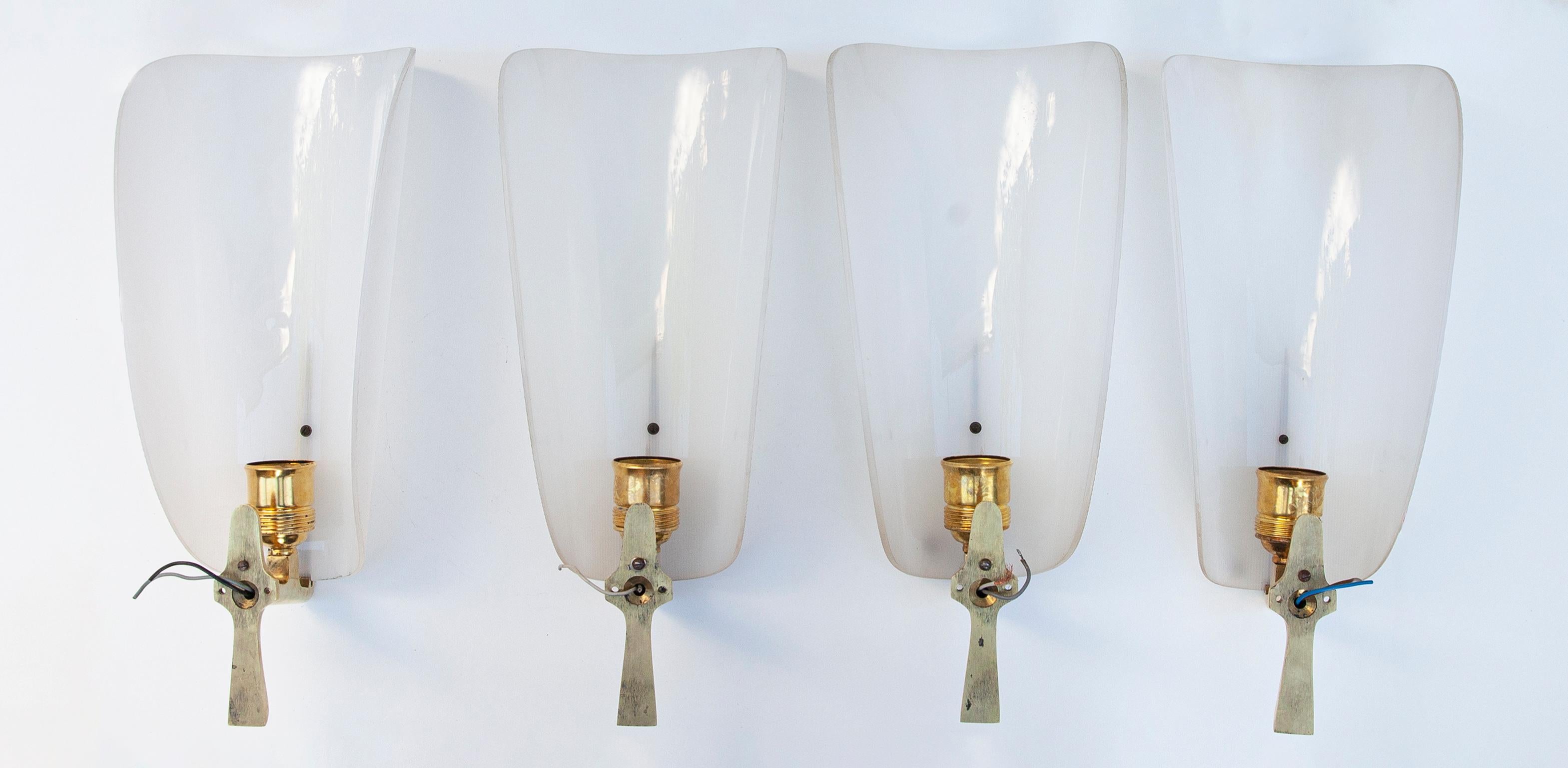 Elegant set of four Maison Arlus wall lamps executed in gilt brass and with a Perspex shade made in France, 1950s. Each lamp has one E24 socket and they are in very good condition.

Measures: 38 H x 16 B x 12 D cm.