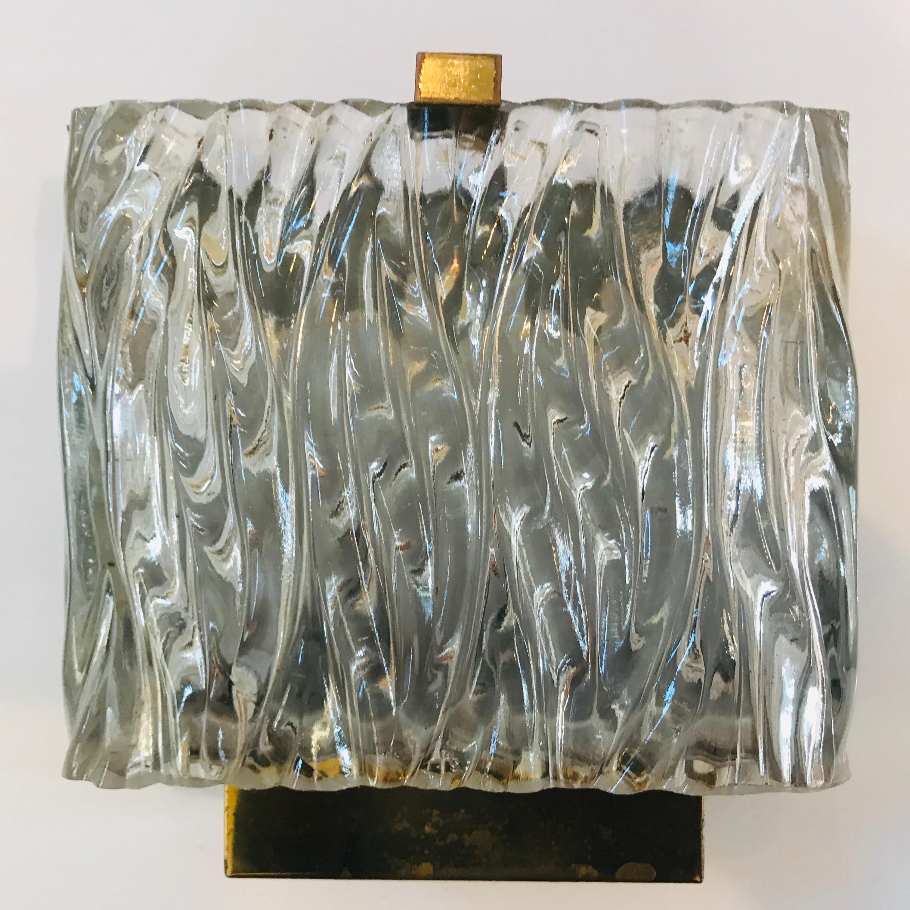 A Maison Arlus French wall light composed of a thick wavy ribbon glass shade and a polished brass frame. Two e12 60w candelabra sockets. Newly Rewired