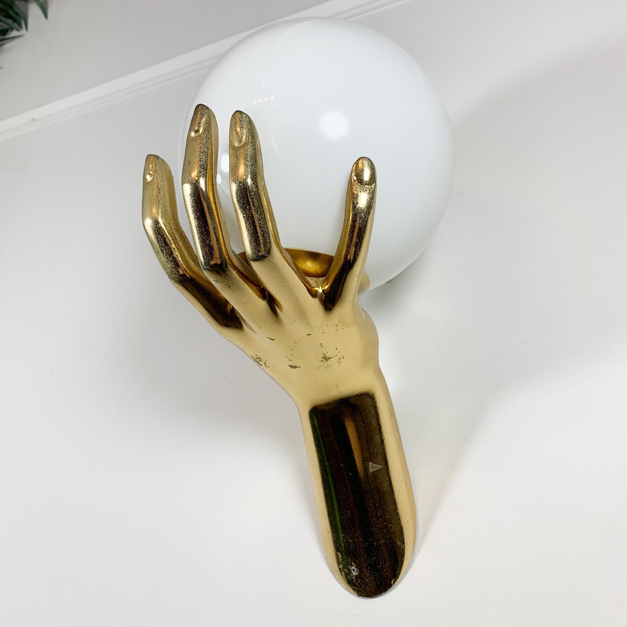 Maison Arlus gilt bronze hand wall sconce.

In superb original condition, with light signs of patina, and bearing the opaline hand blown glass shade. This piece has a bright gold finish.

Dating from the mid-1970s, France.

An outstanding