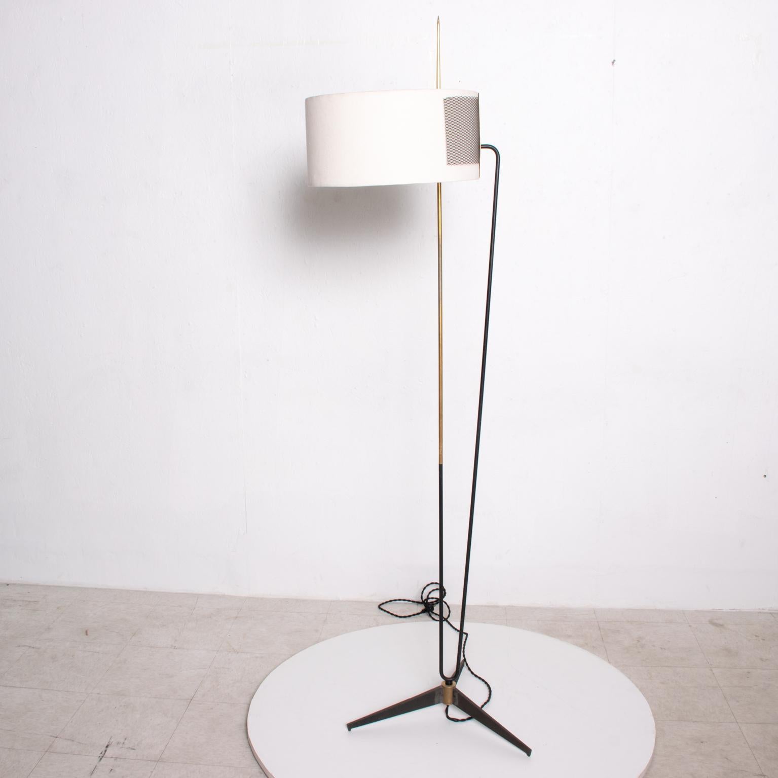 For your consideration, a beautiful tripod floor lamp made in France circa the 1950s. Produced by Arlus. Magnificent design with a unique tripod base, sculptural body in tubular steel and bronze. The round drum shade displays clean modern lines with