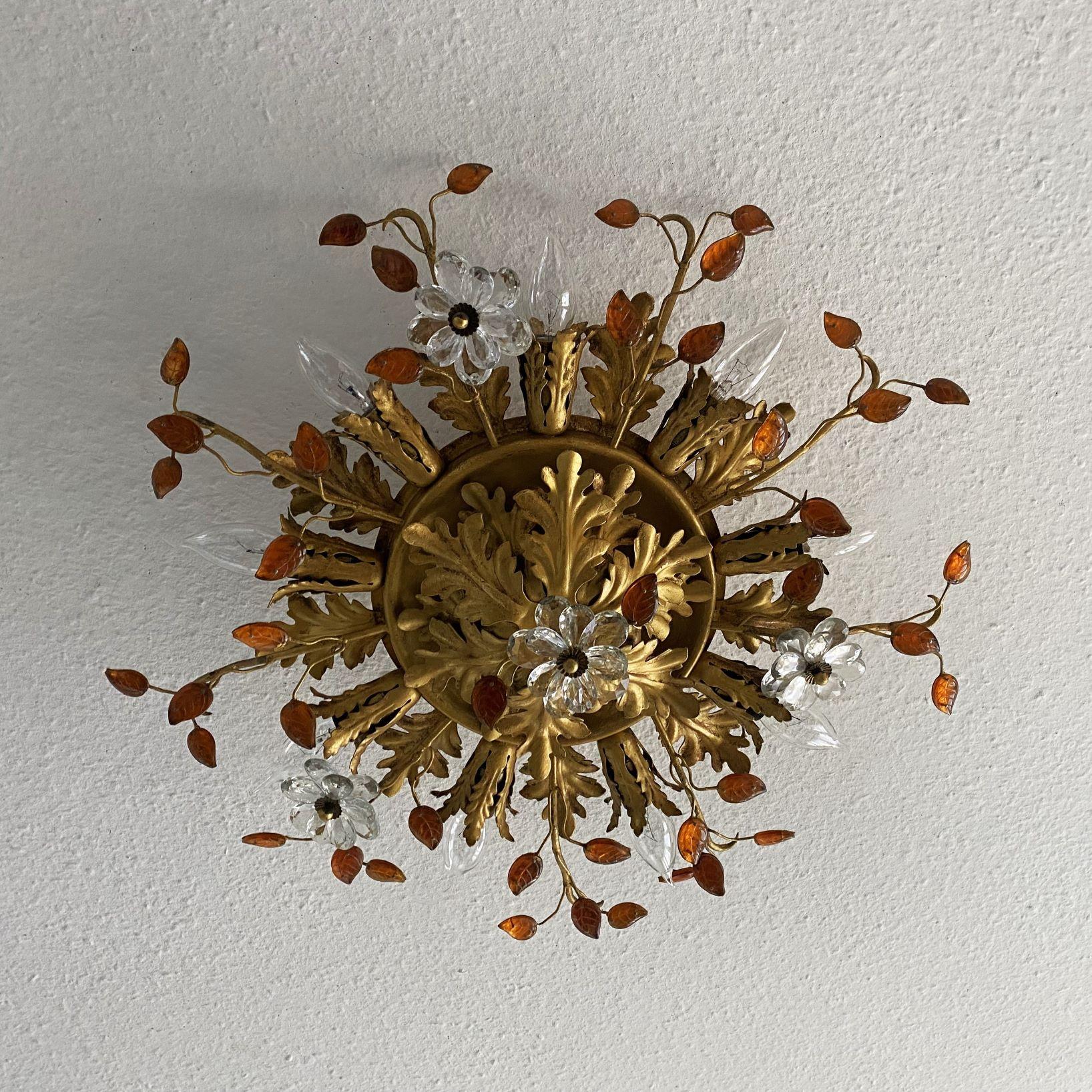 Large gilt Iron and crystal nine-Light flush mount by Maison Baguès, France, 1940s. Wonderful art environment handcrafted in iron gild with gold leaf beautifuly decorate with amber glass leaves and clear crystal double flowers. The amber color of