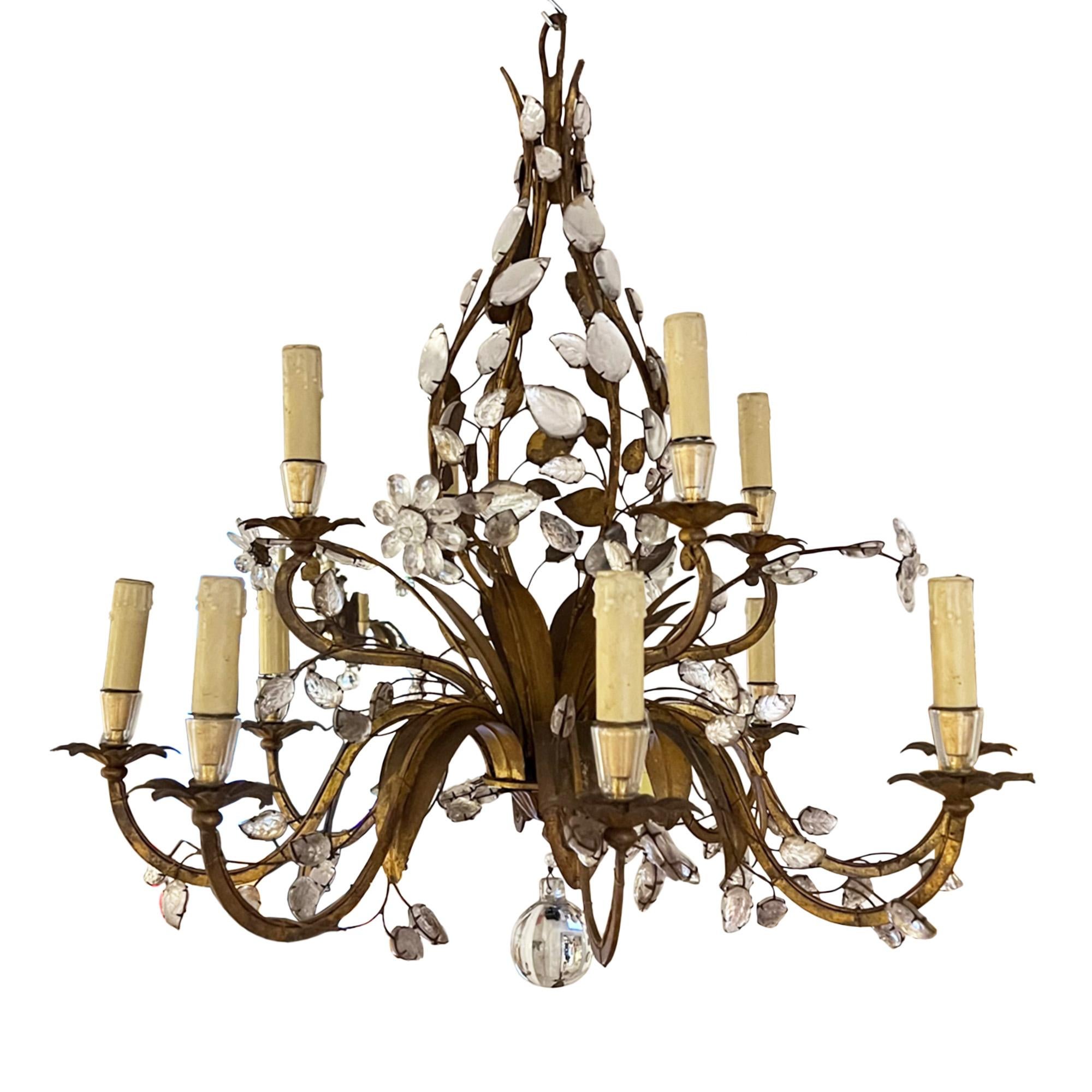 Wonderfully elegant mid 20th century gilt metal and crystal chandelier by Maison Baguès. Made in Paris in the 1960s.

This light has 8 arms, with the light fitting in the shape of an open bud. Decorated with crystal leaves and flowers - this is a