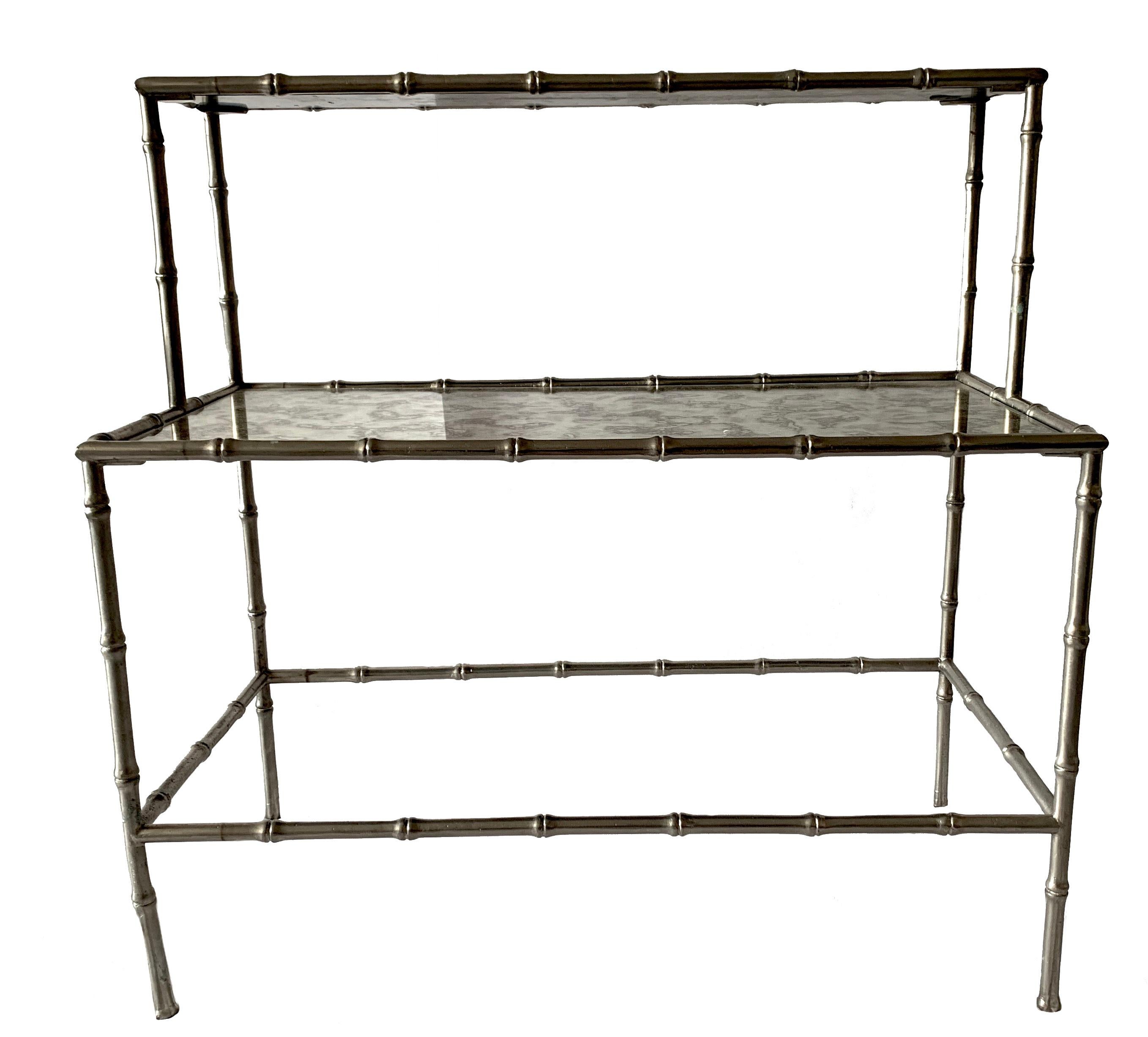 Maison Baguès attributed bamboo style two-tier table in polished nickel finish. Antique style mirrored glass top. Two-tier design. Measures: First tier is 16