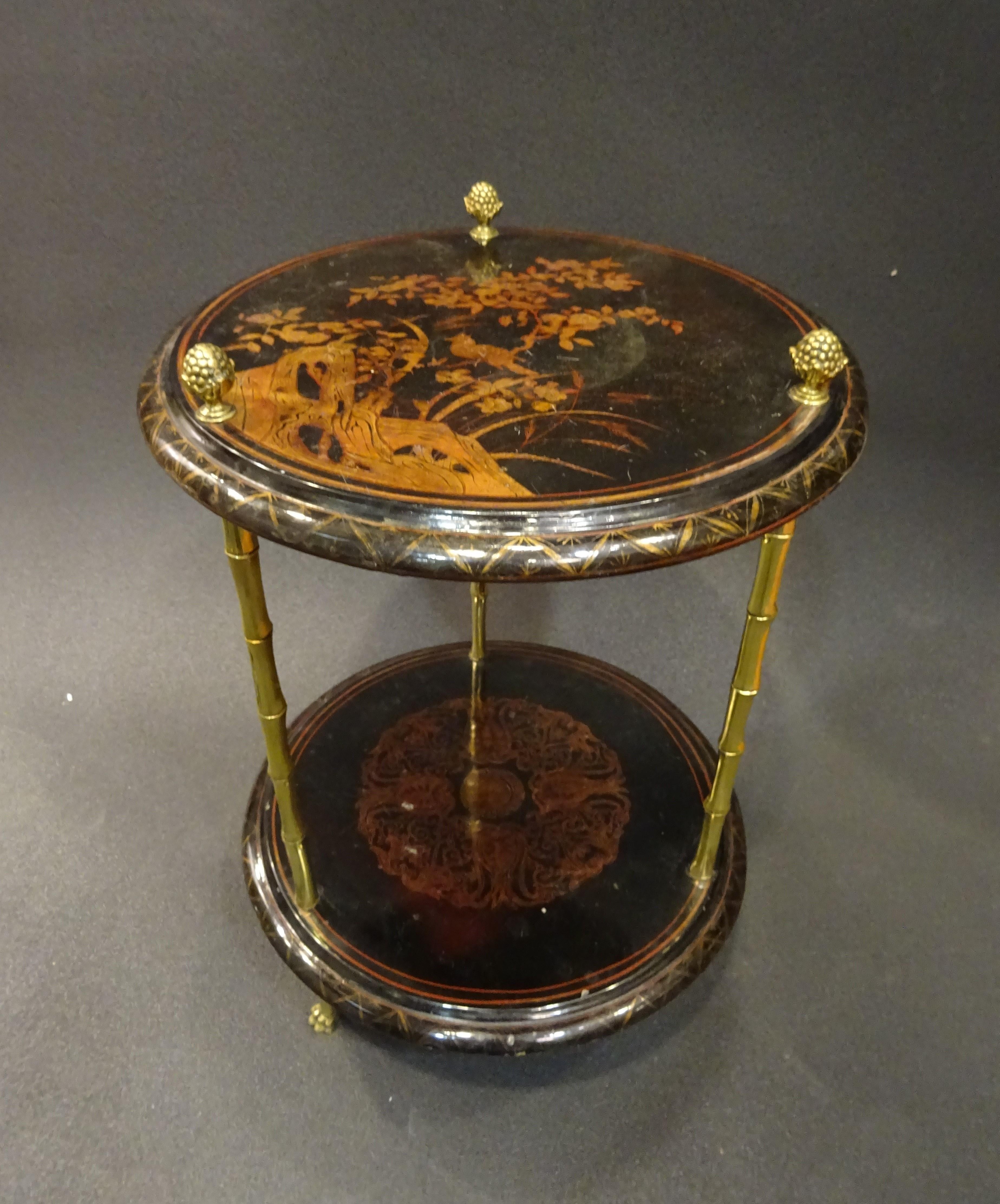 Amazing and very refined end table or gueridon by Maison Bagues, Paris, France, 1970s. 2-tier table in black lacquered good and gilt chinoiserie. Bamboo imitating legs in gilt bronce with pineapple-shaped finished.
In a very good condition with age