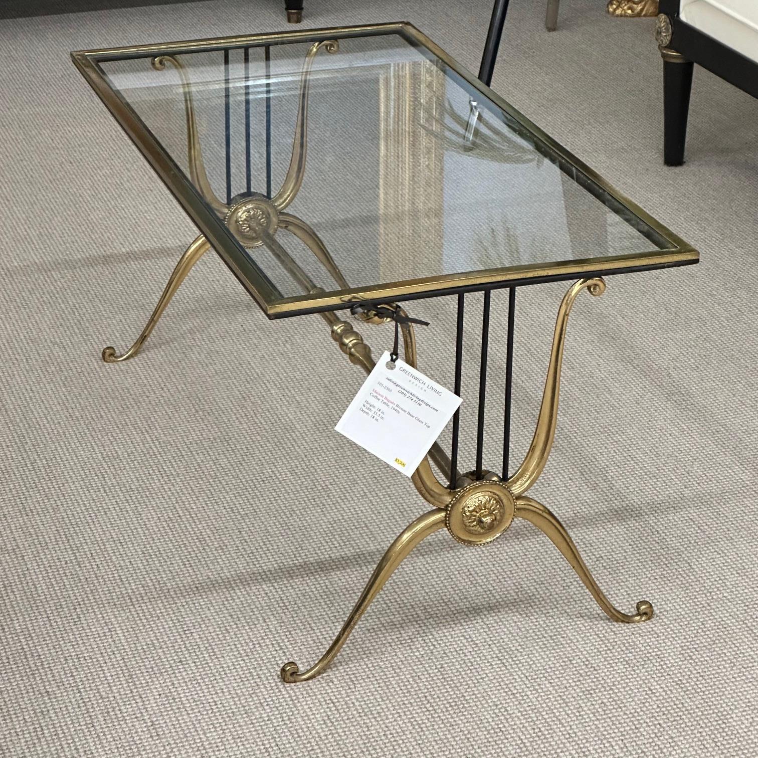 Maison Baguès bronze coffee table. Glass top with bronze base with base having harp shaped supports with Floret Centers. Piedmont style legs with scrolled feet.