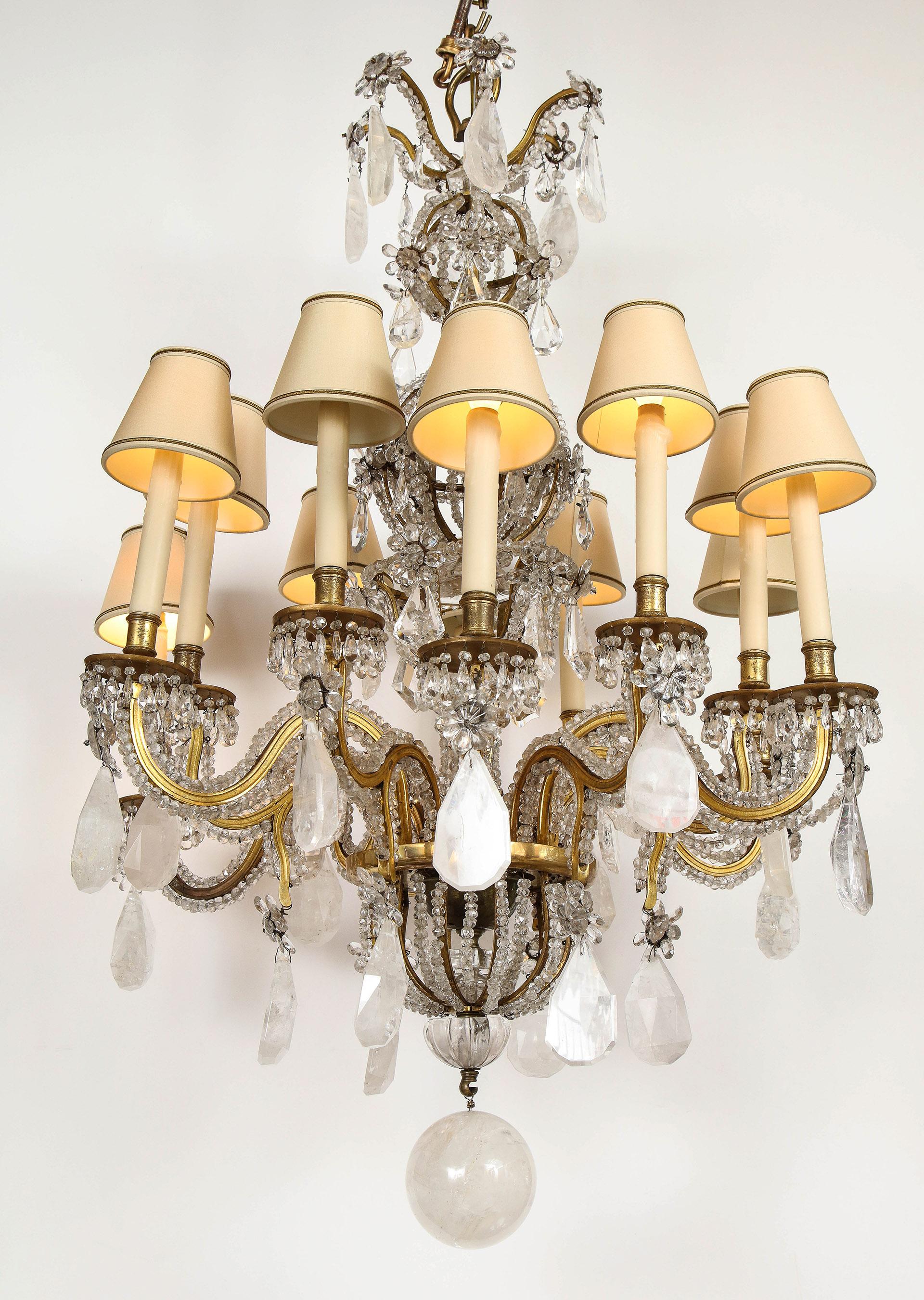 Grand scale rock crystal and doré bronze chandelier by Maison Baguès

A rare rock crystal chandelier by Maison Baguès in the Louis XV style, having 12 candle lights with an electrified interior crystal cage. The doré bronze frame decorated with