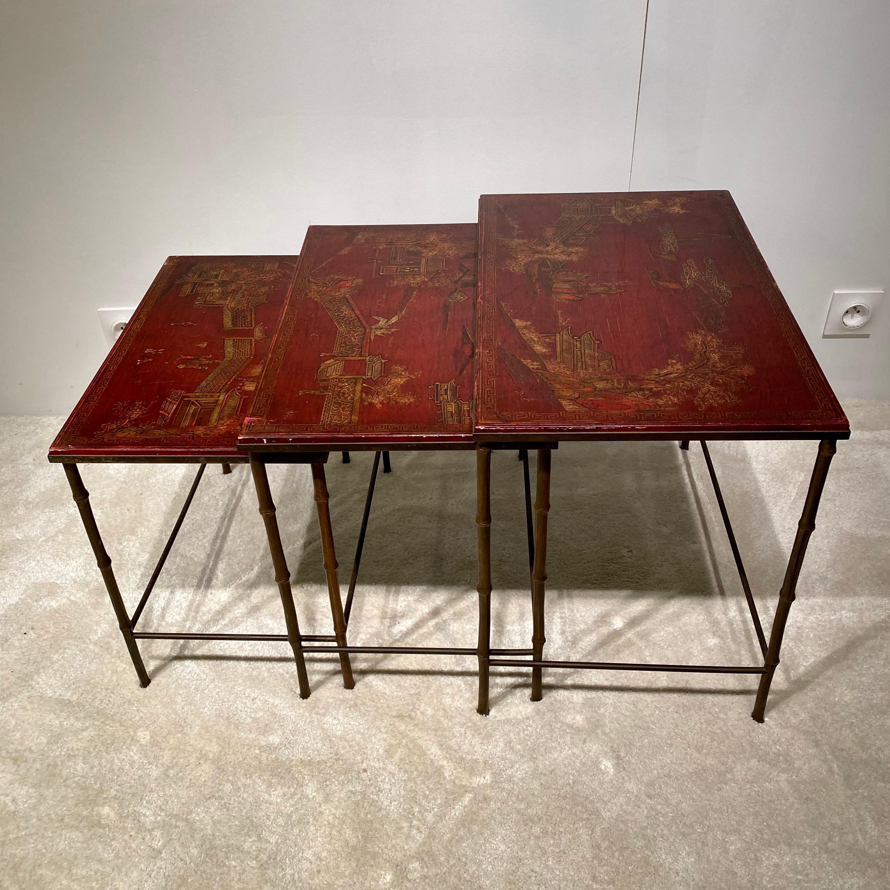 A set of three vintage nesting tables produced by Maison Bagues recognisable by the faux bamboo feet in brass.
A rich burgundy colour lacquered table tops with delicate gold Chinese style designs.
Elegant tables, easy to place to give a French